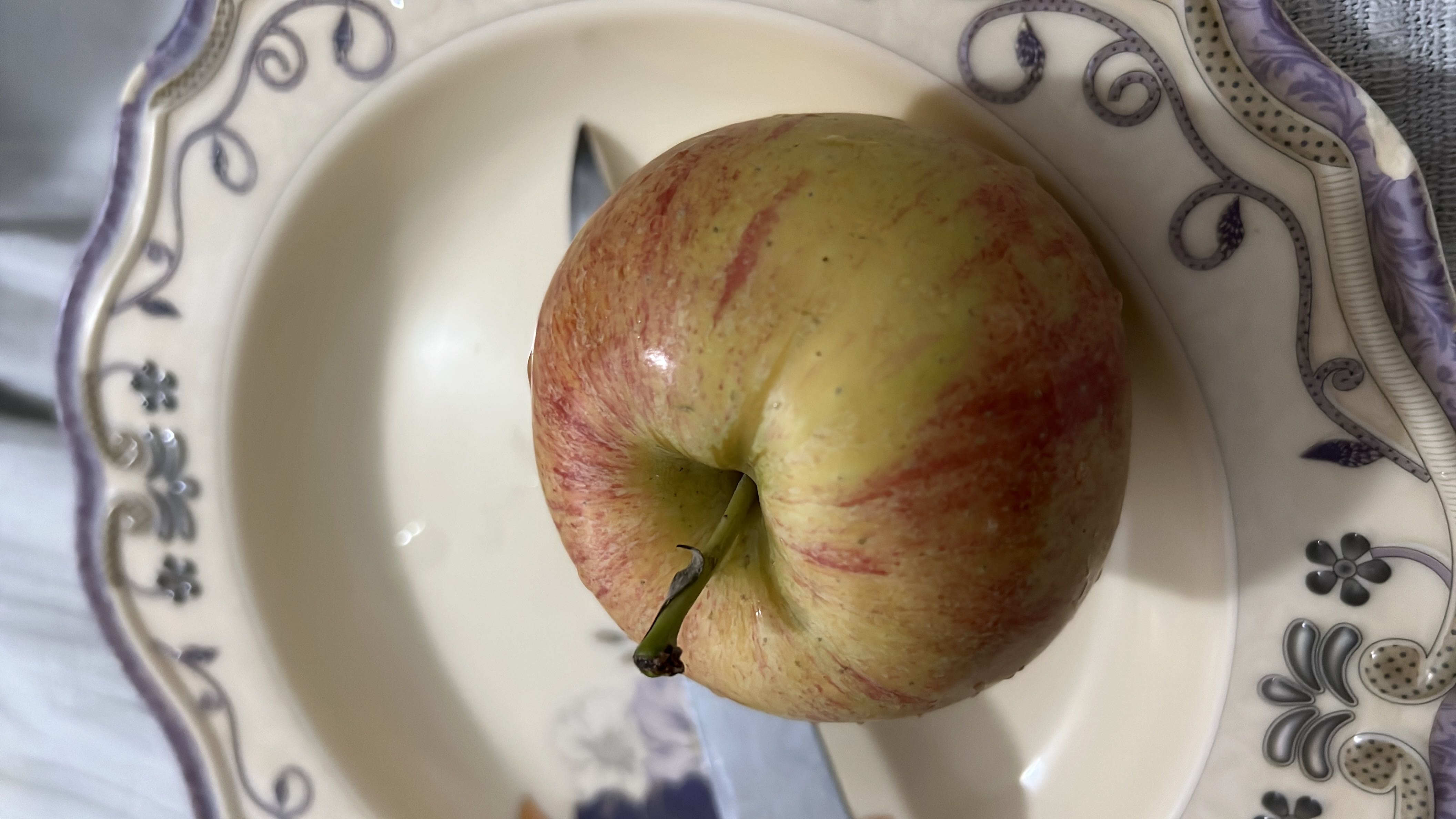 The image shows a fresh apple, which is a nutritious fruit rich in carbohydrates and low in fats and protein.