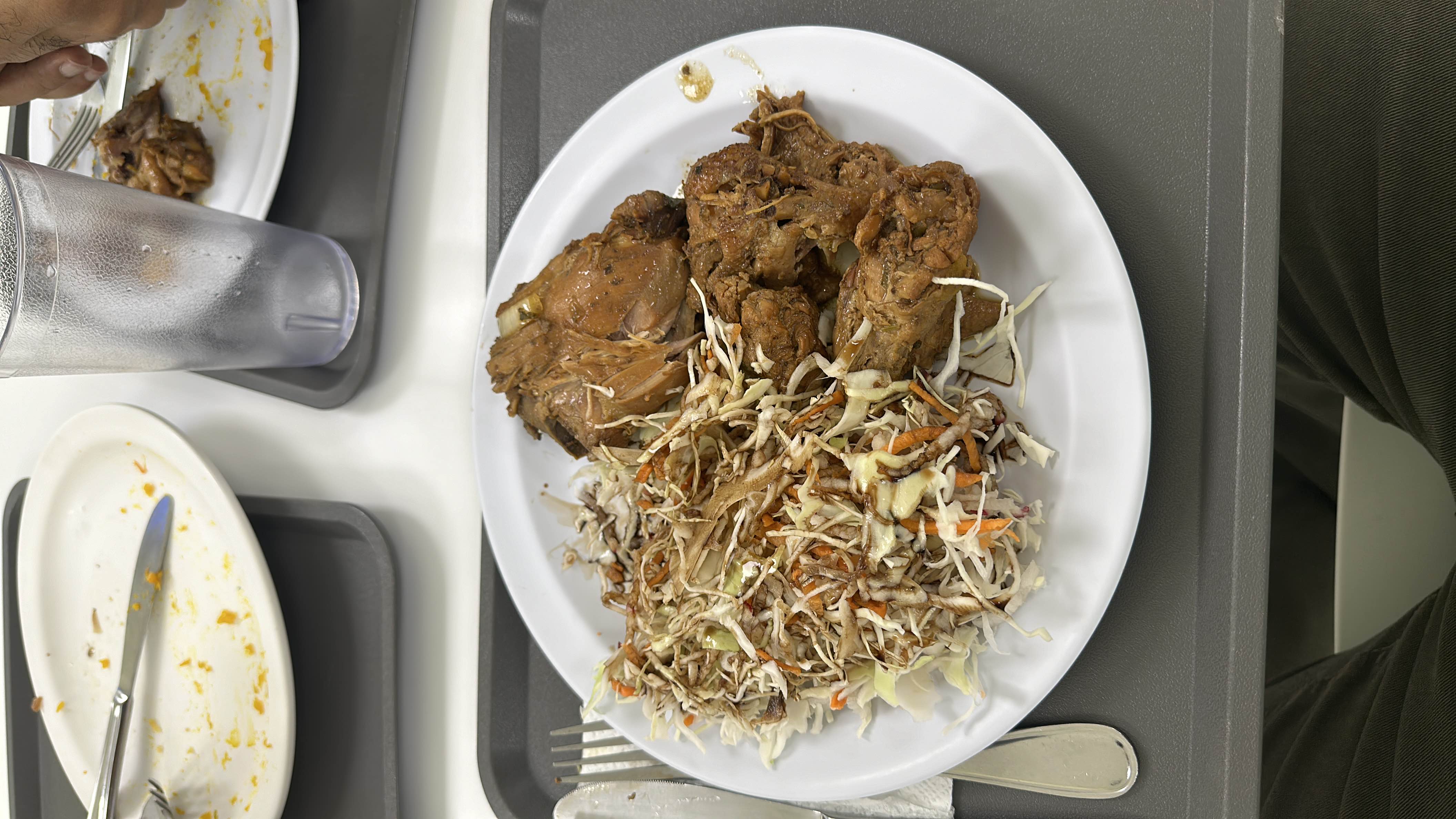 A plate of roasted chicken paired with a fresh coleslaw salad, providing a balanced mix of protein, fats, and carbohydrates.