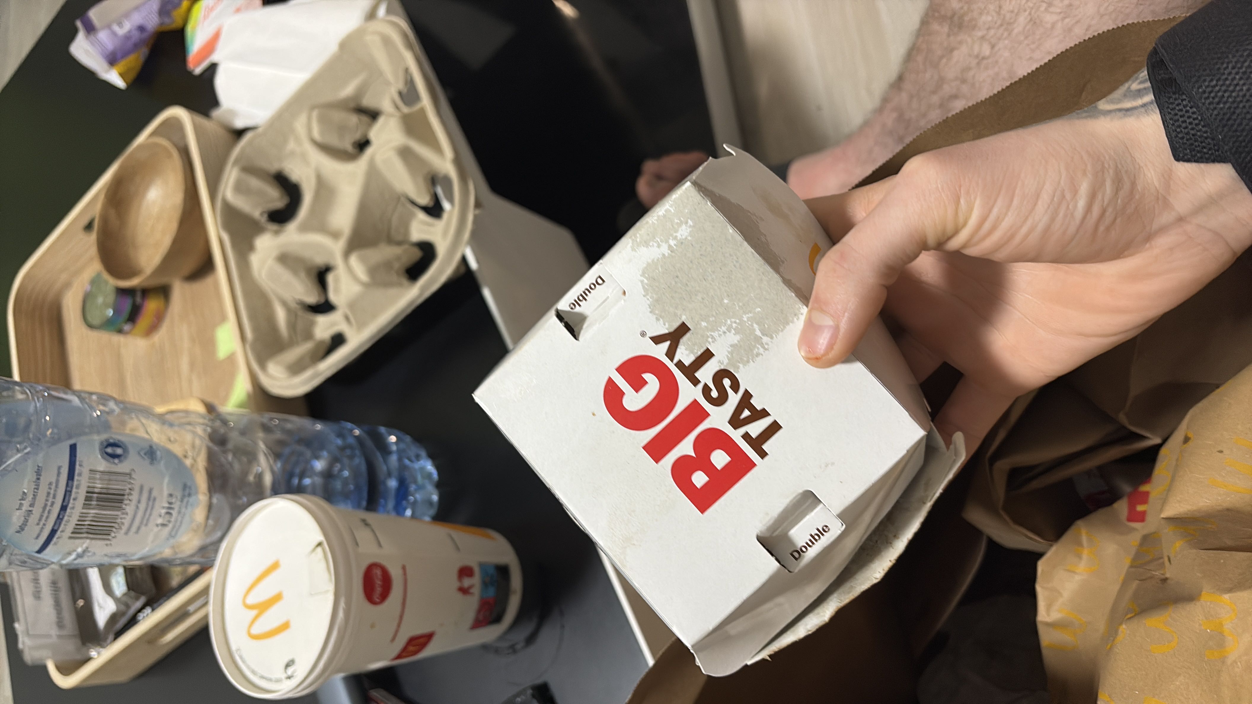 The image shows a McDonald's Big Tasty meal, which is a high-calorie fast food item containing beef, cheese, sauce, and vegetables.