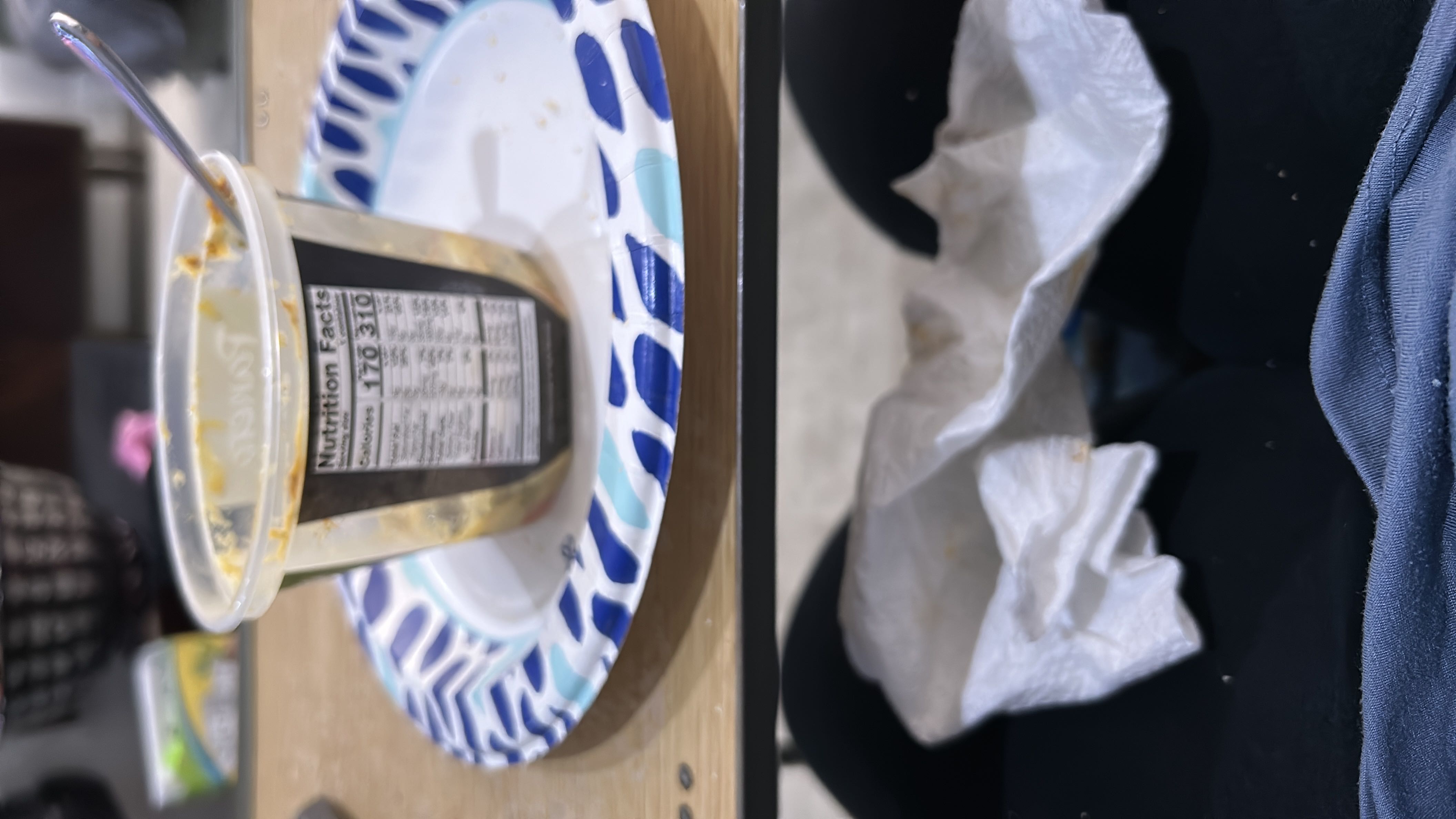 The image shows a container of peanut butter with nutritional information indicating 310 calories per serving, along with protein, carbs, and fats content.