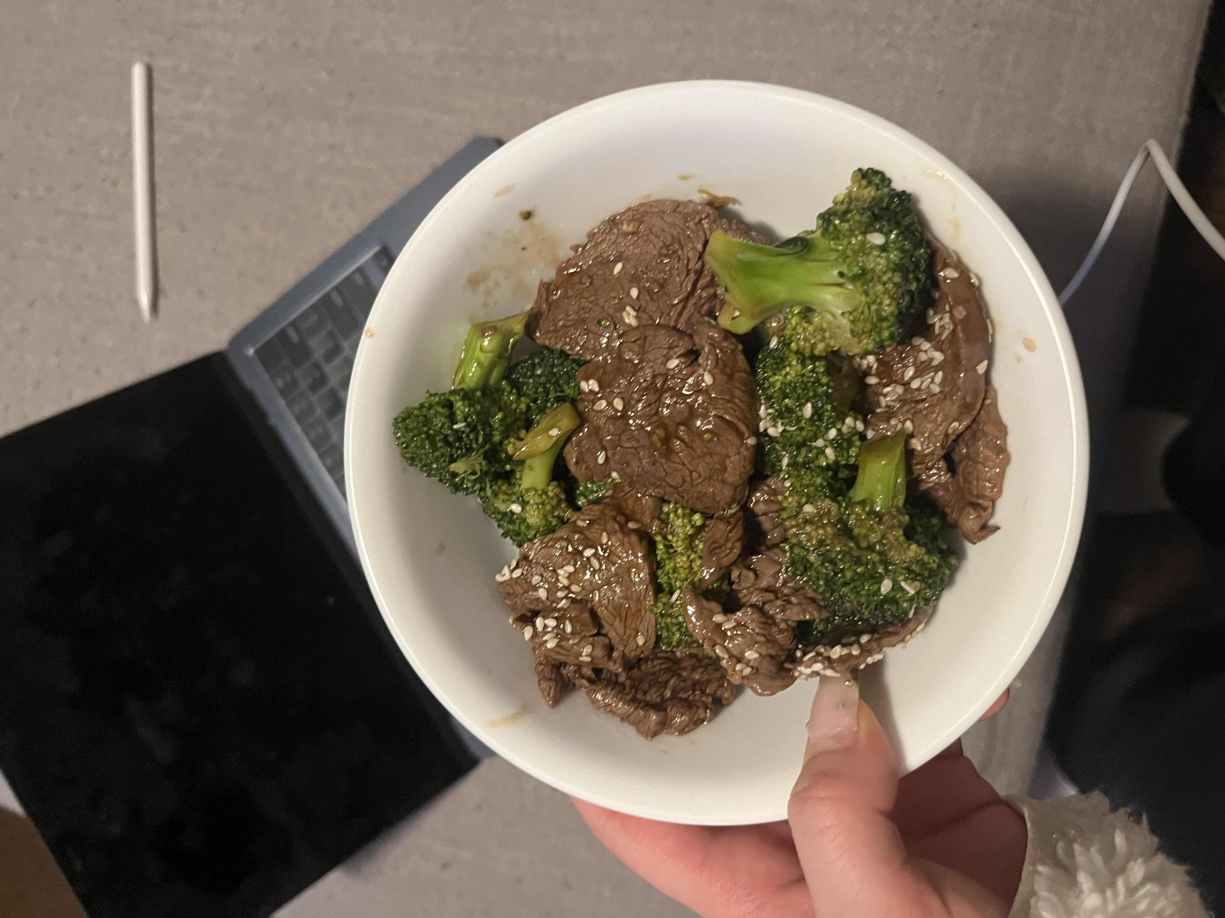A nutritious dish consisting of beef, broccoli, and sesame seeds, providing a balanced mix of protein, carbs, and fats.