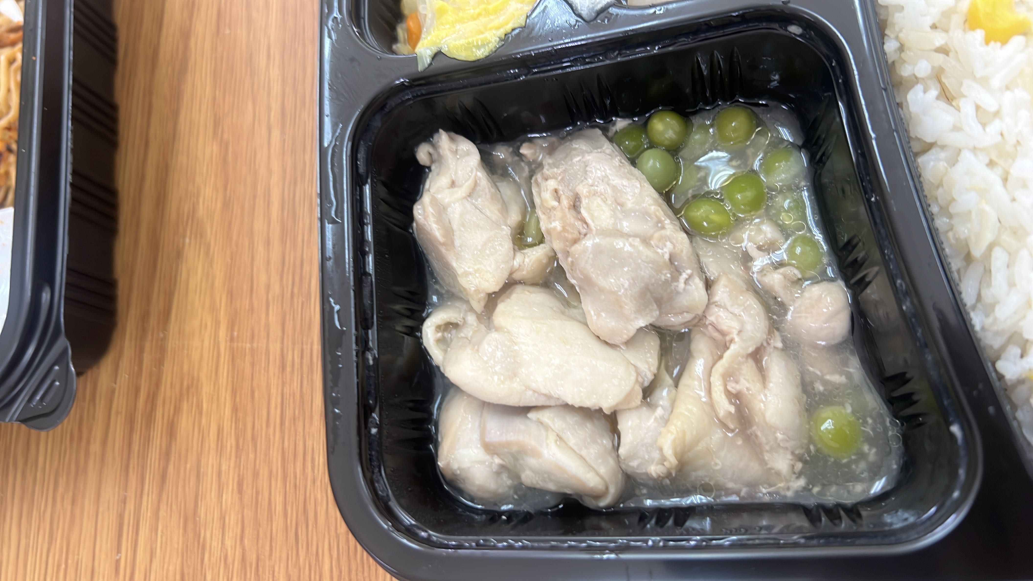 A meal consisting of chicken, peas, and rice, providing a balanced mix of protein, carbohydrates, and fats.