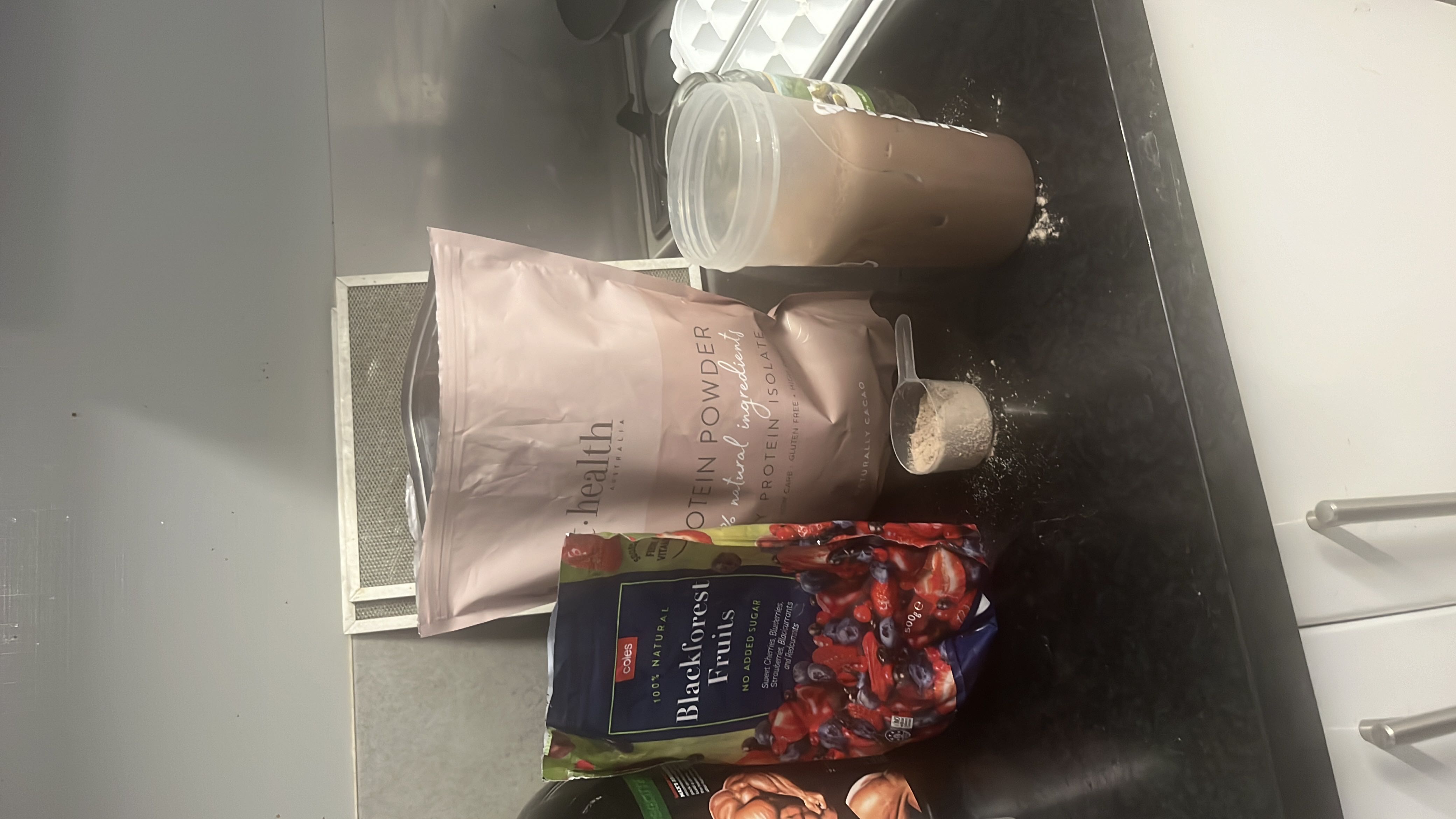 A protein shake made with protein powder, blackforest fruits, and milk, providing a balanced mix of protein, carbs, and fats.