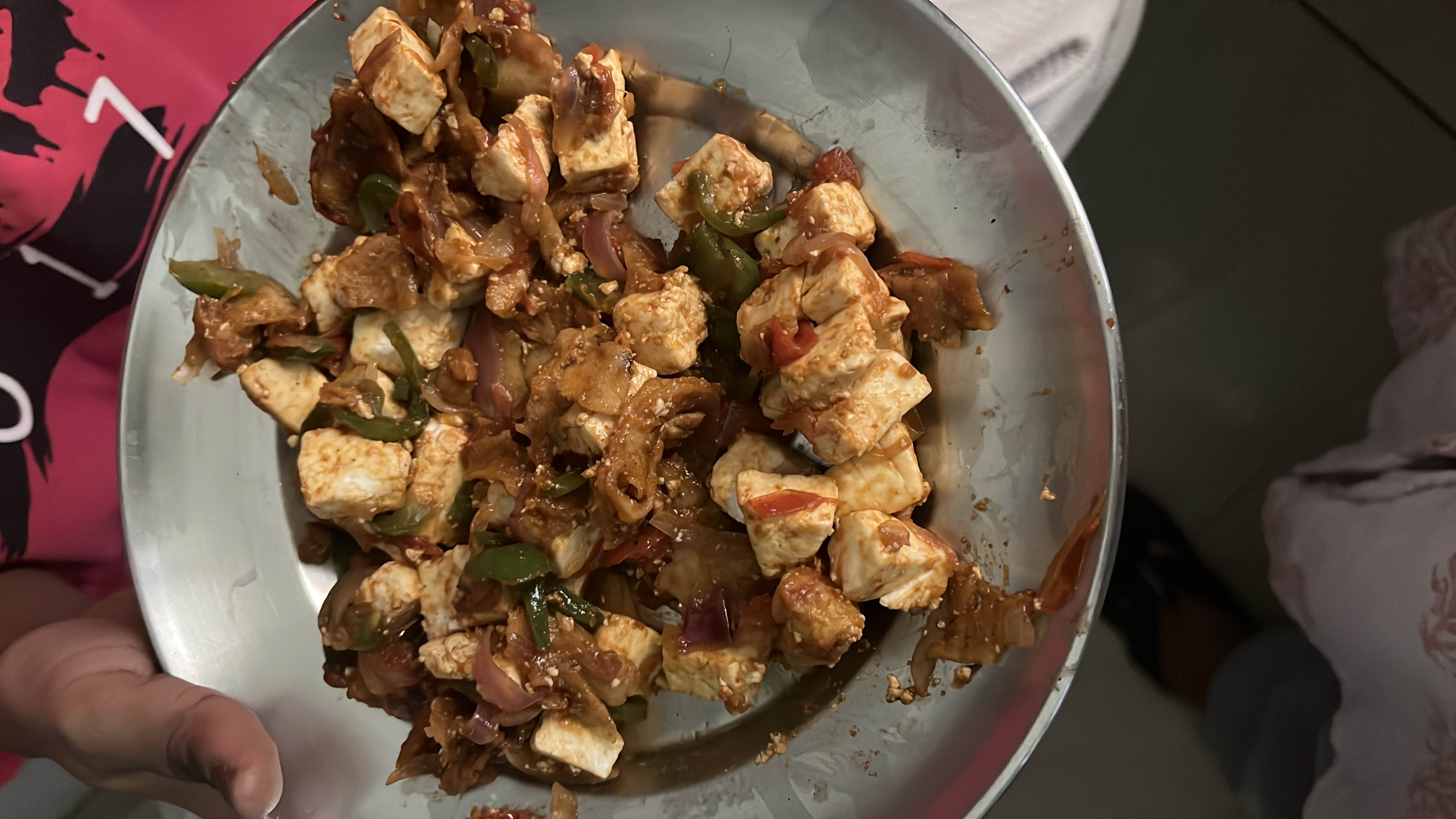 A stir-fried dish made with paneer, capsicum, onions, and tomatoes, seasoned with spices.