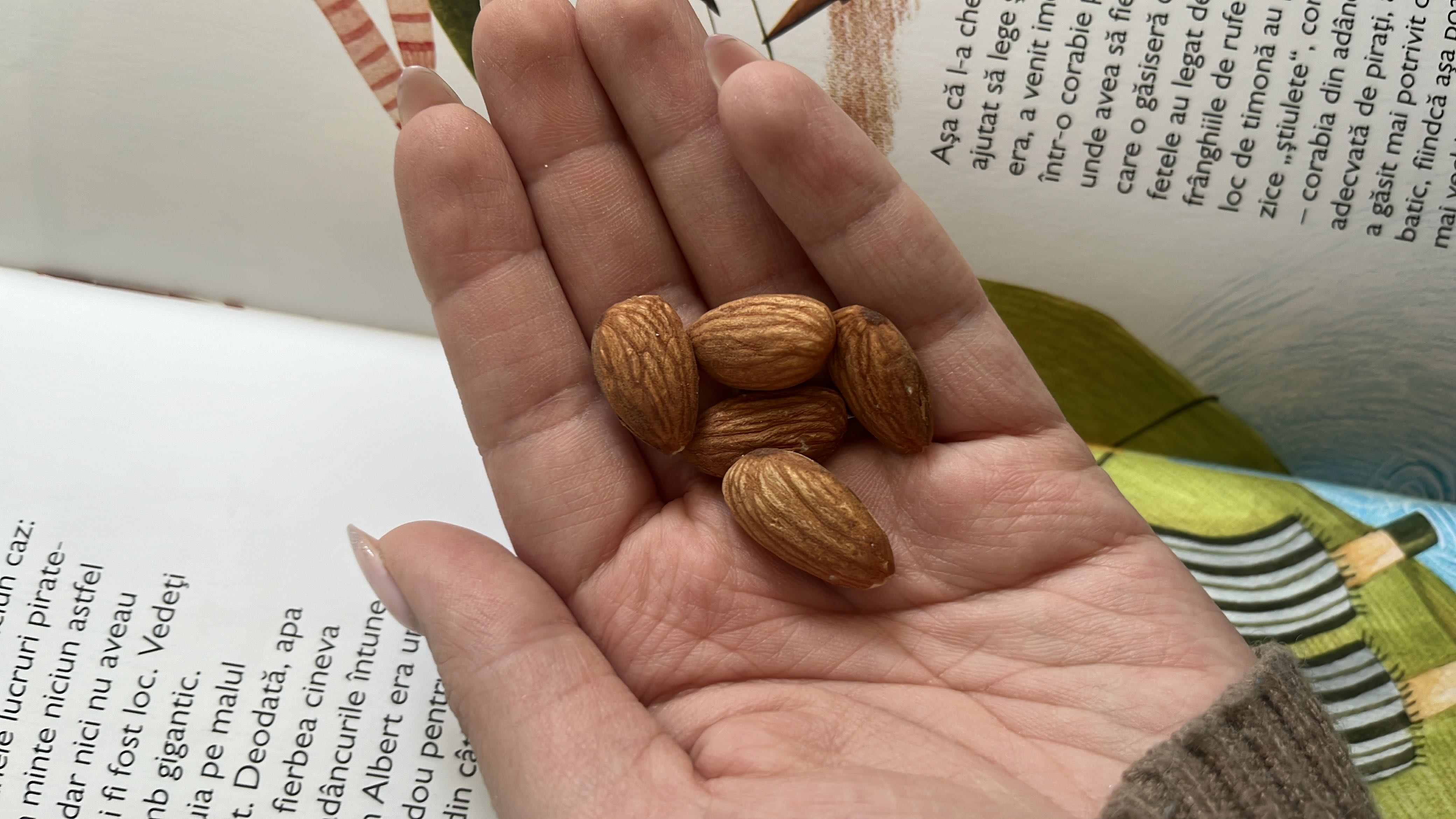 The image shows a handful of almonds, which are a nutritious snack rich in healthy fats, protein, and fiber.