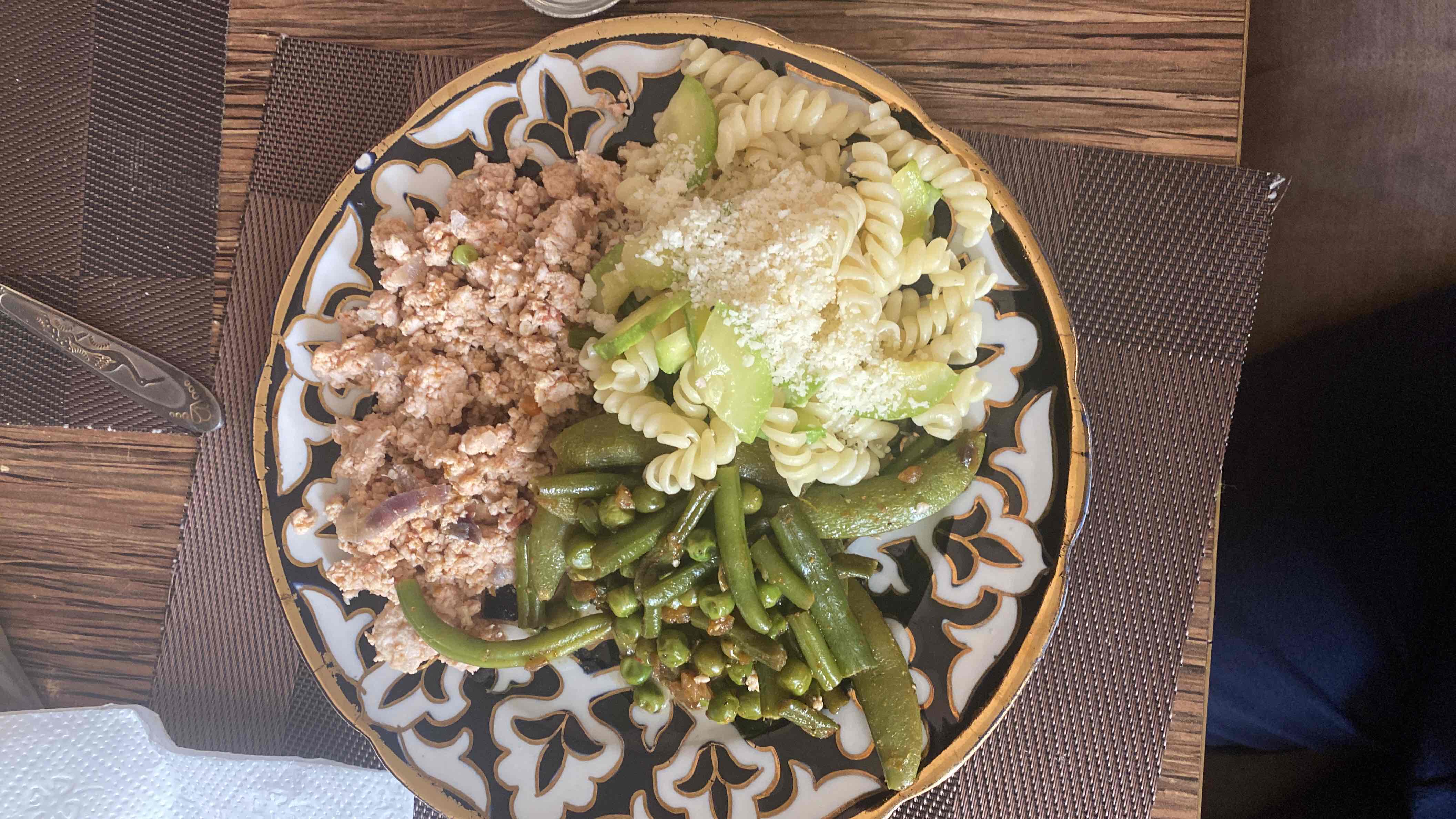 A balanced meal consisting of ground chicken, green beans, peas, pumpkin, and parmesan cheese, providing a good mix of protein, carbs, and fats.