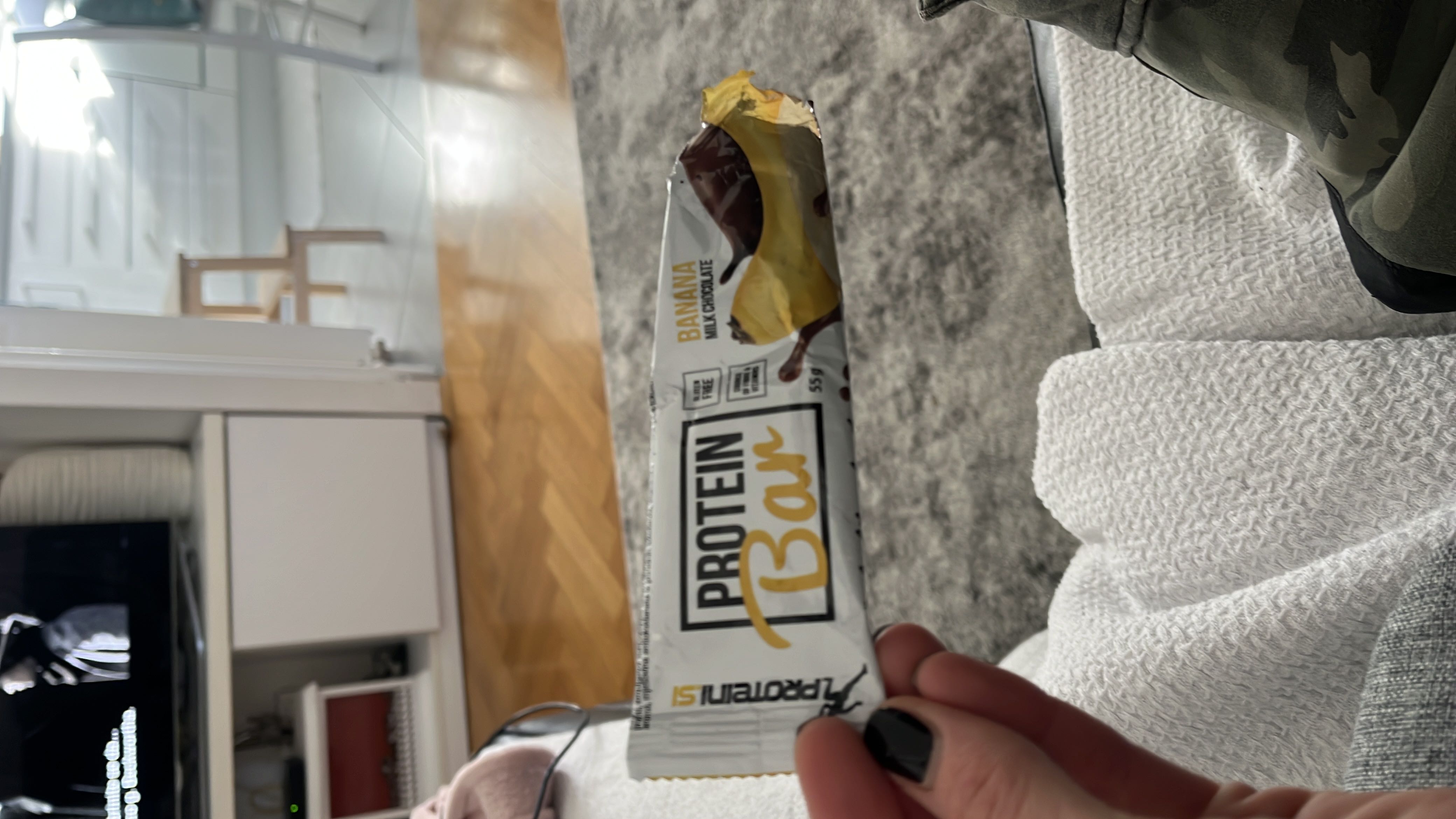 A banana-flavored protein bar coated with milk chocolate, providing a balanced mix of protein, carbs, and fats.