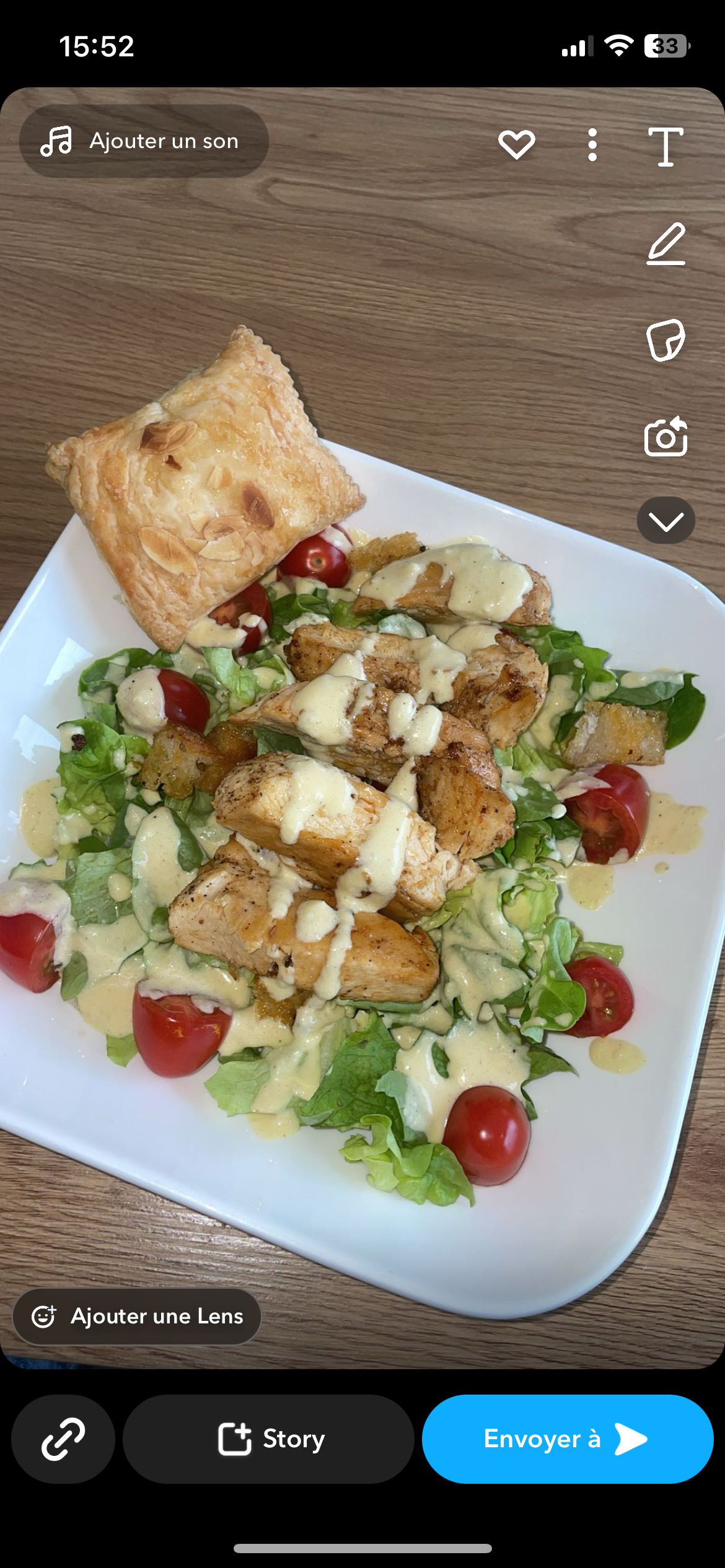 A healthy salad with grilled chicken, fresh vegetables, and a creamy dressing, accompanied by a puff pastry.