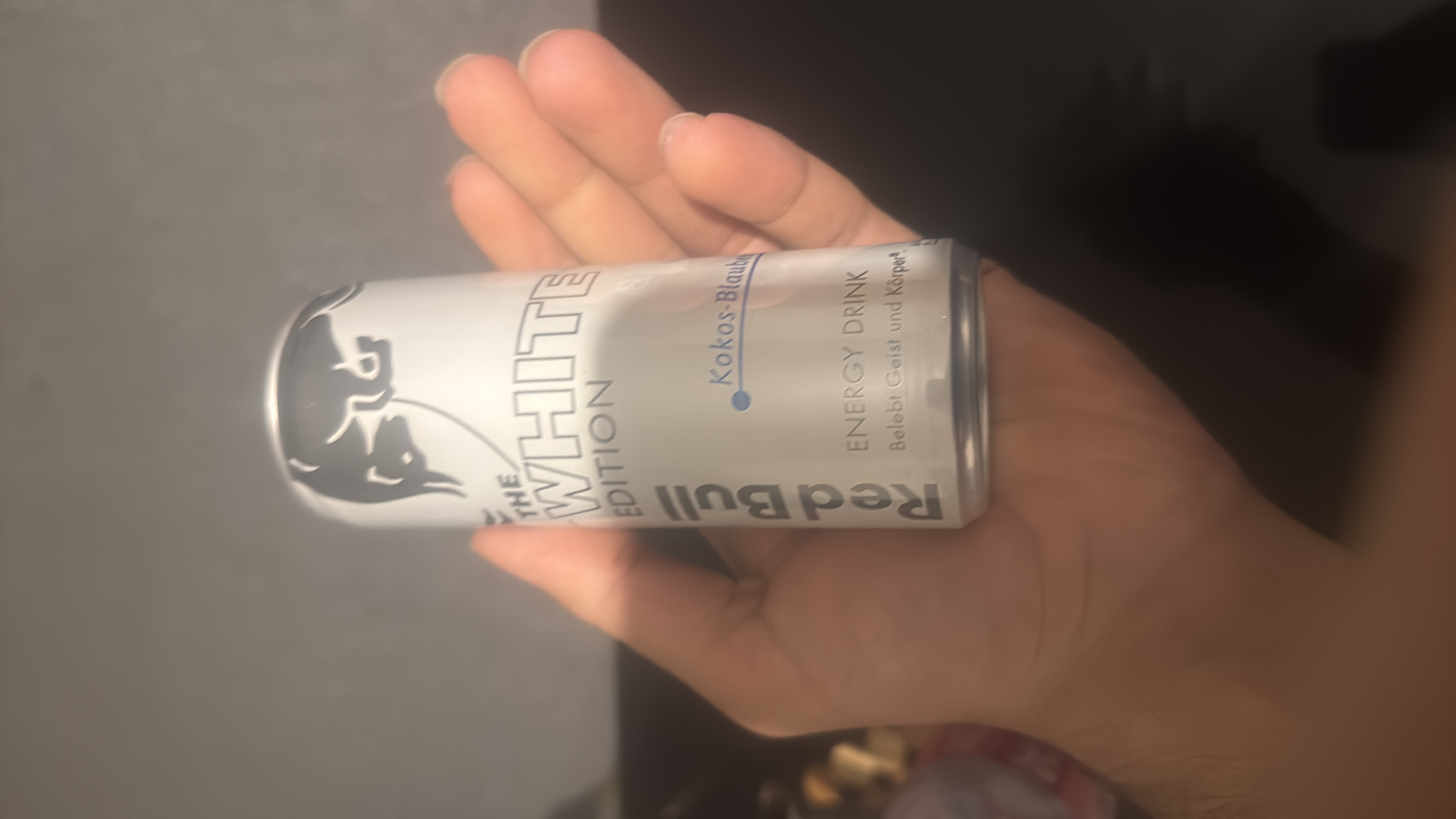 The image shows a can of Red Bull White Edition energy drink with a coconut-blueberry flavor, containing 45 calories per serving.