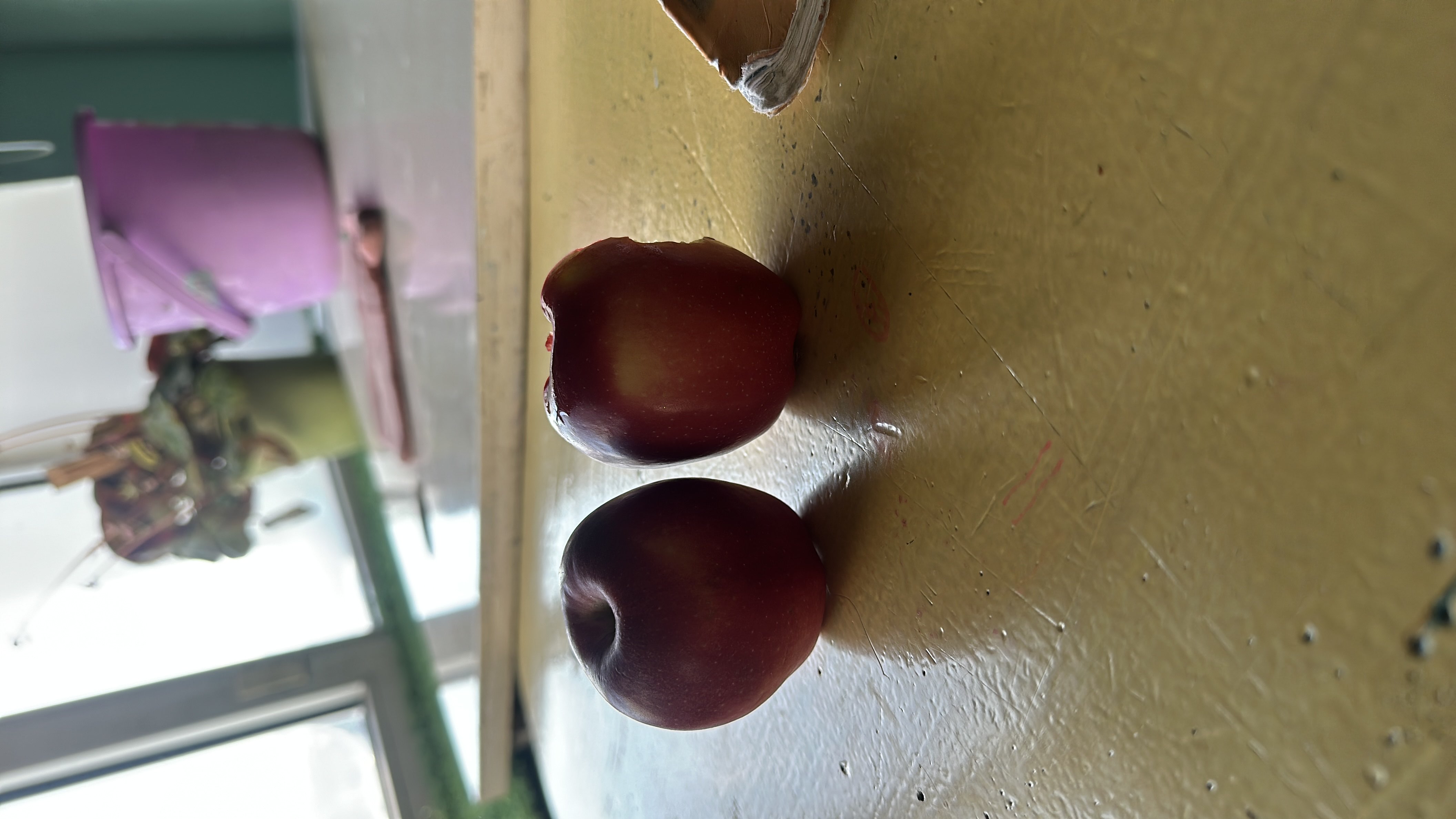 The image shows two fresh apples, which are low in calories, high in carbohydrates, and provide a good health score.