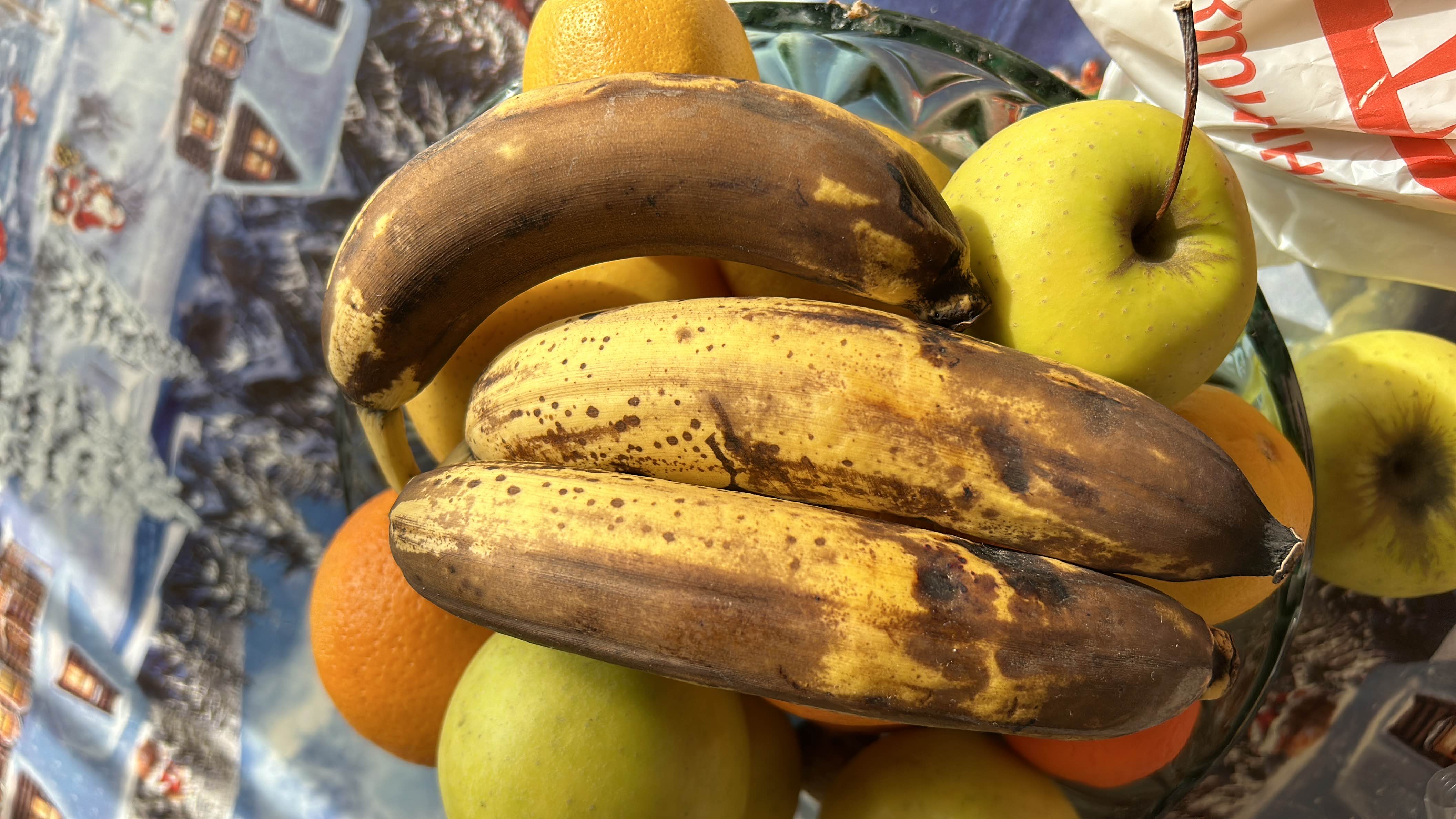 A bowl of ripe bananas, apples, and oranges, providing a nutritious mix of natural sugars, fiber, and vitamins.