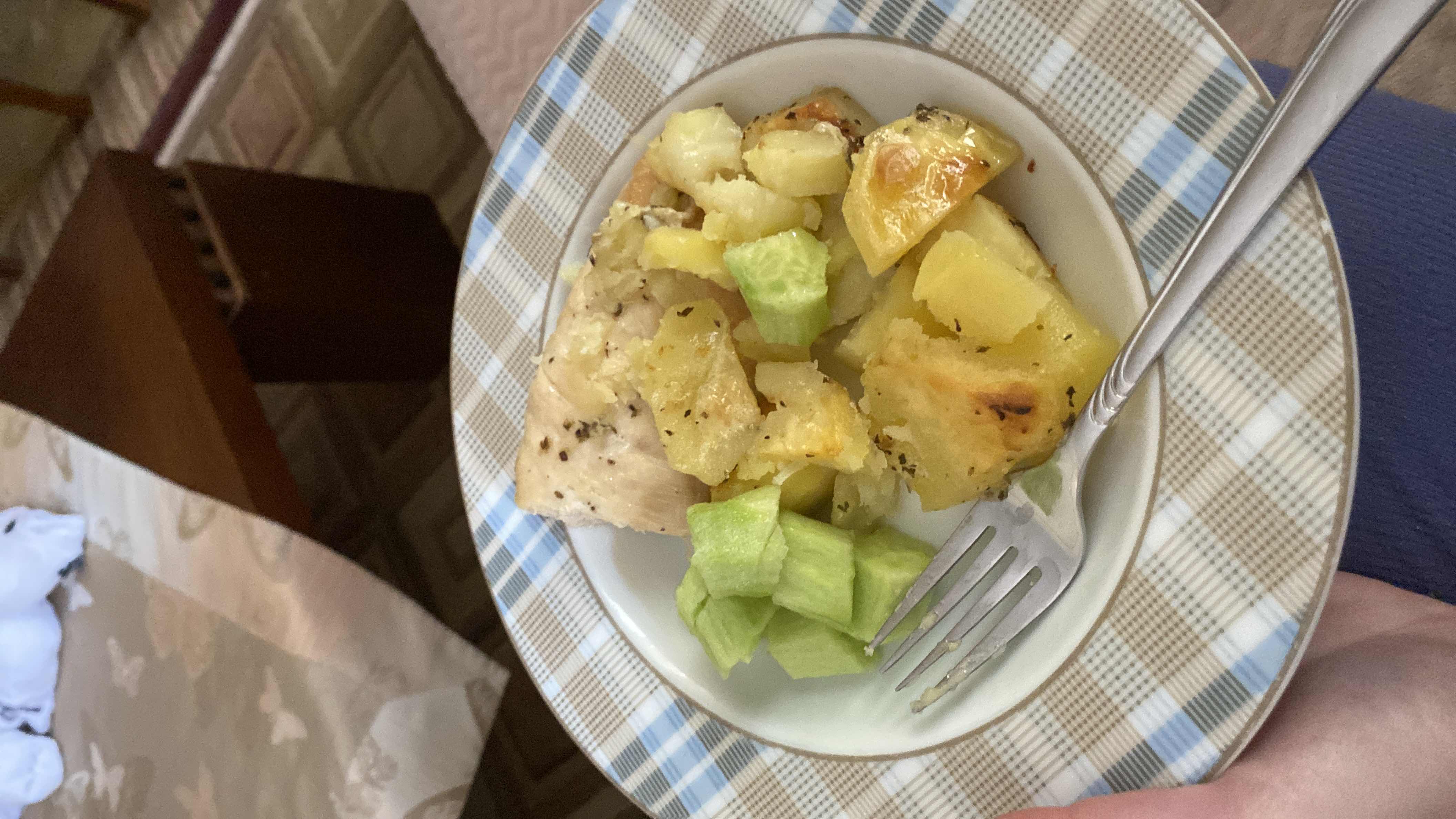 A balanced meal consisting of roasted chicken breast, potatoes, and fresh cucumber slices.