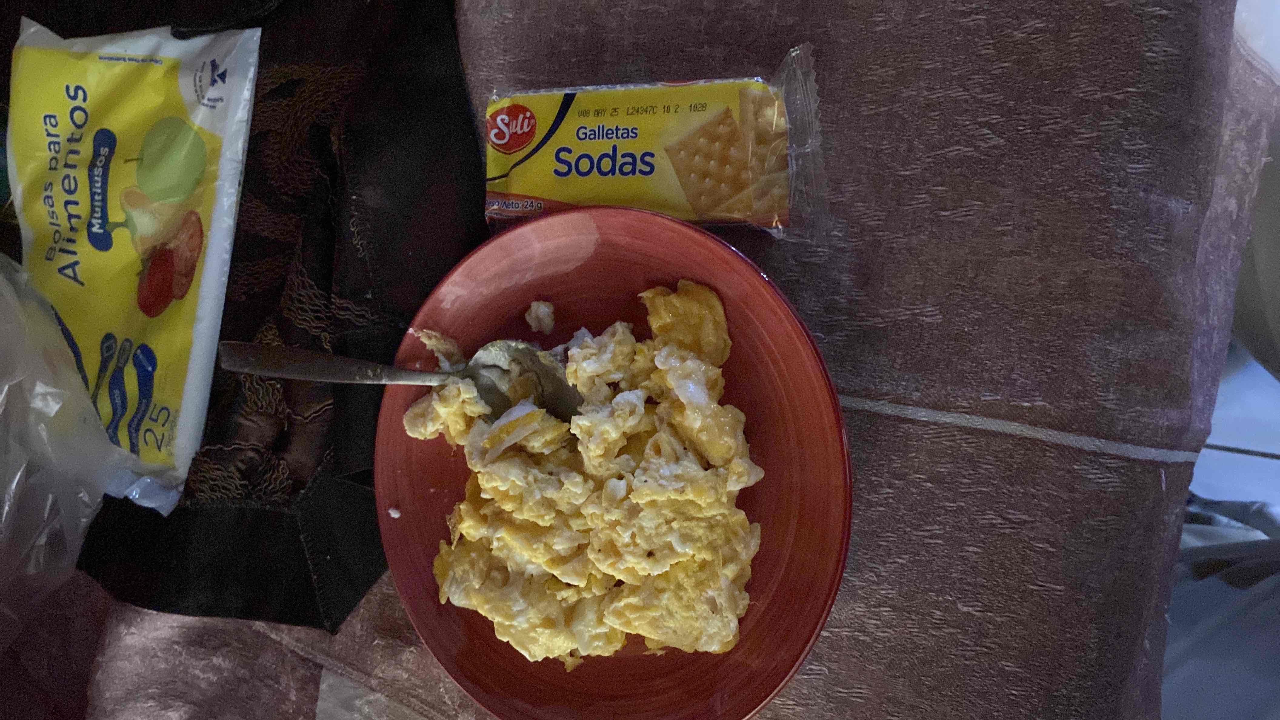 A meal consisting of scrambled eggs and soda crackers, providing a balanced mix of protein, carbs, and fats.