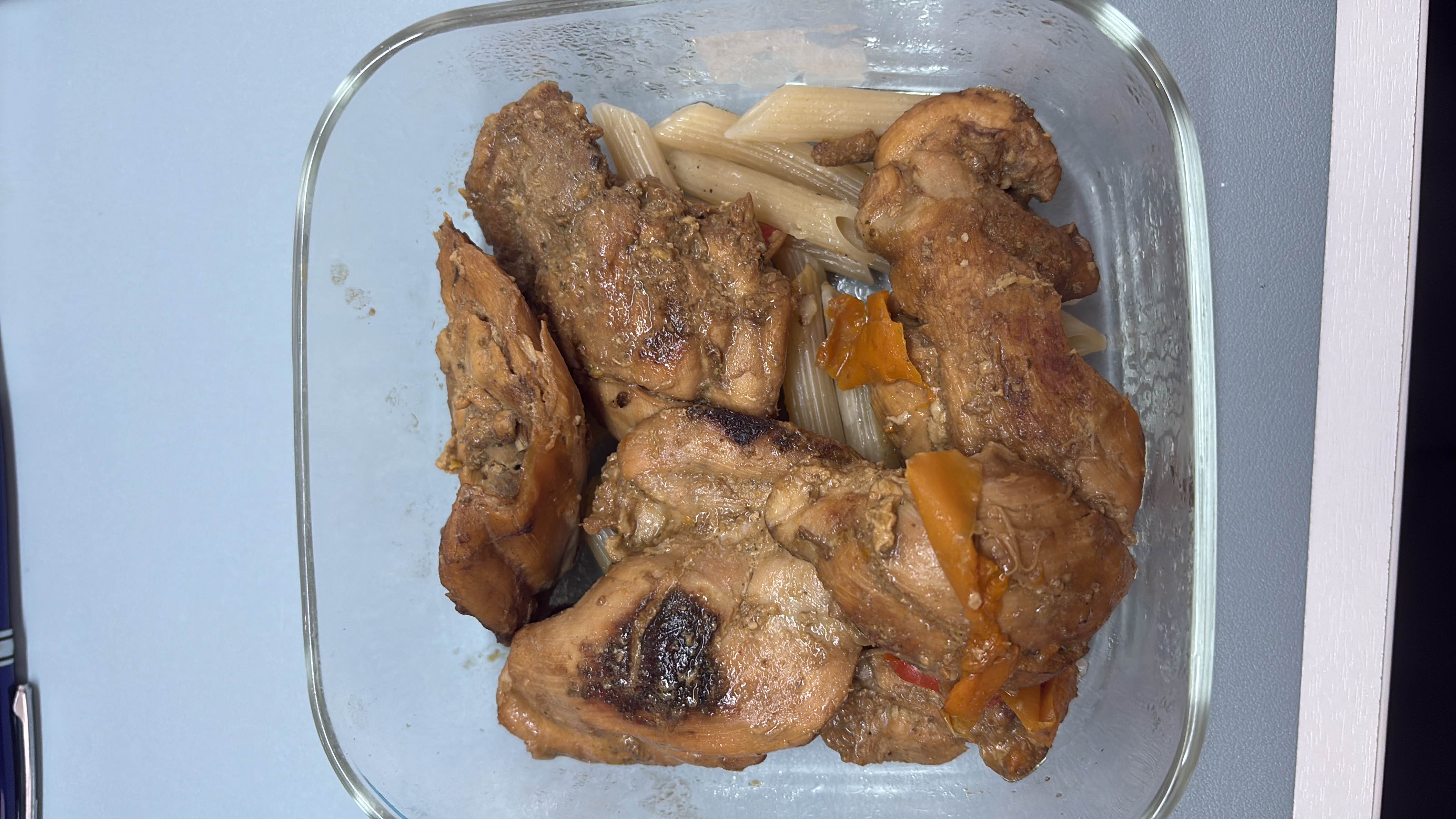 A dish consisting of grilled chicken, pasta, and vegetables, providing a balanced mix of protein, carbs, and fats.