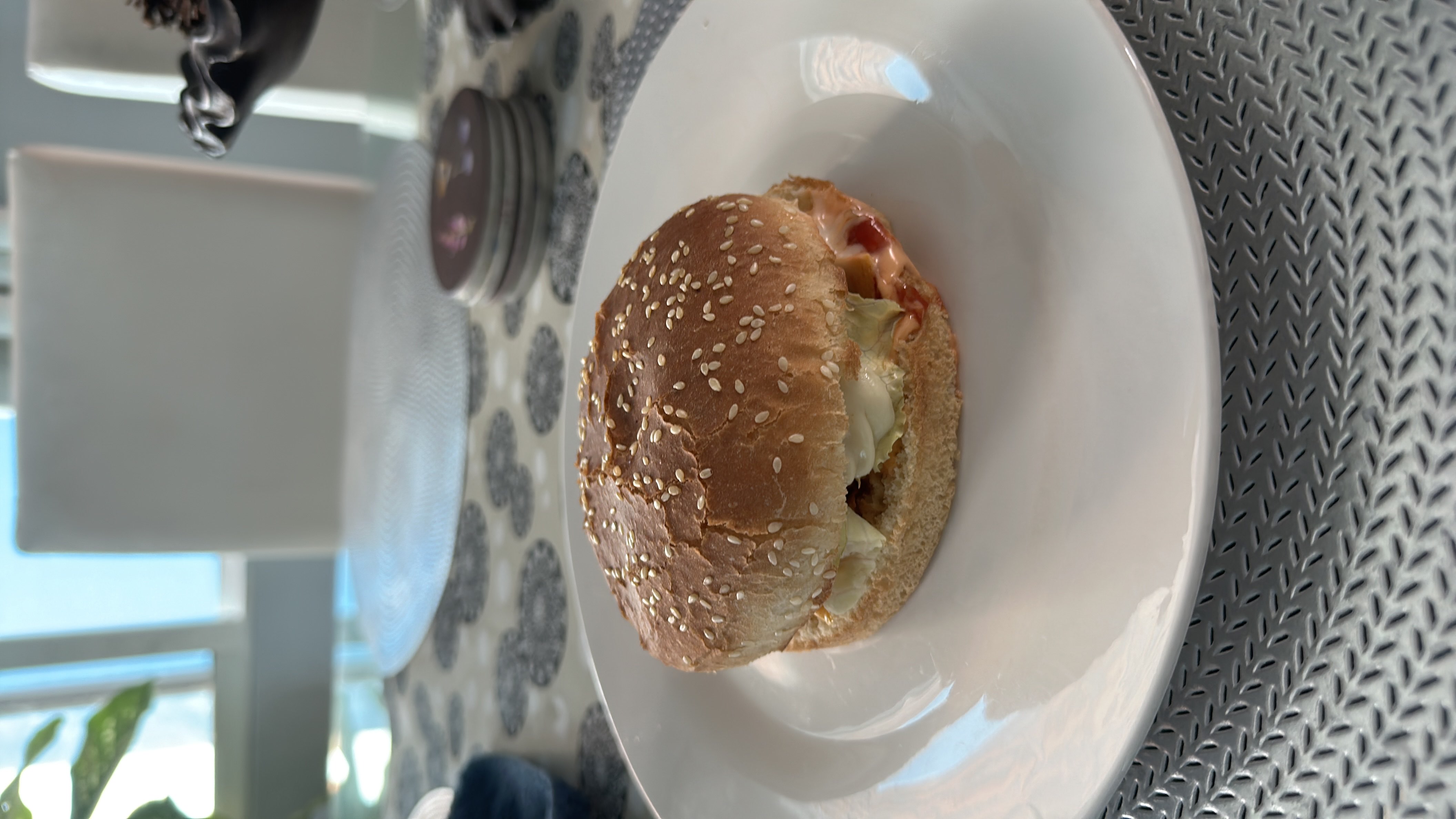 A burger with a sesame seed bun, lettuce, cheese, and a patty, providing a balanced mix of protein, carbs, and fats.