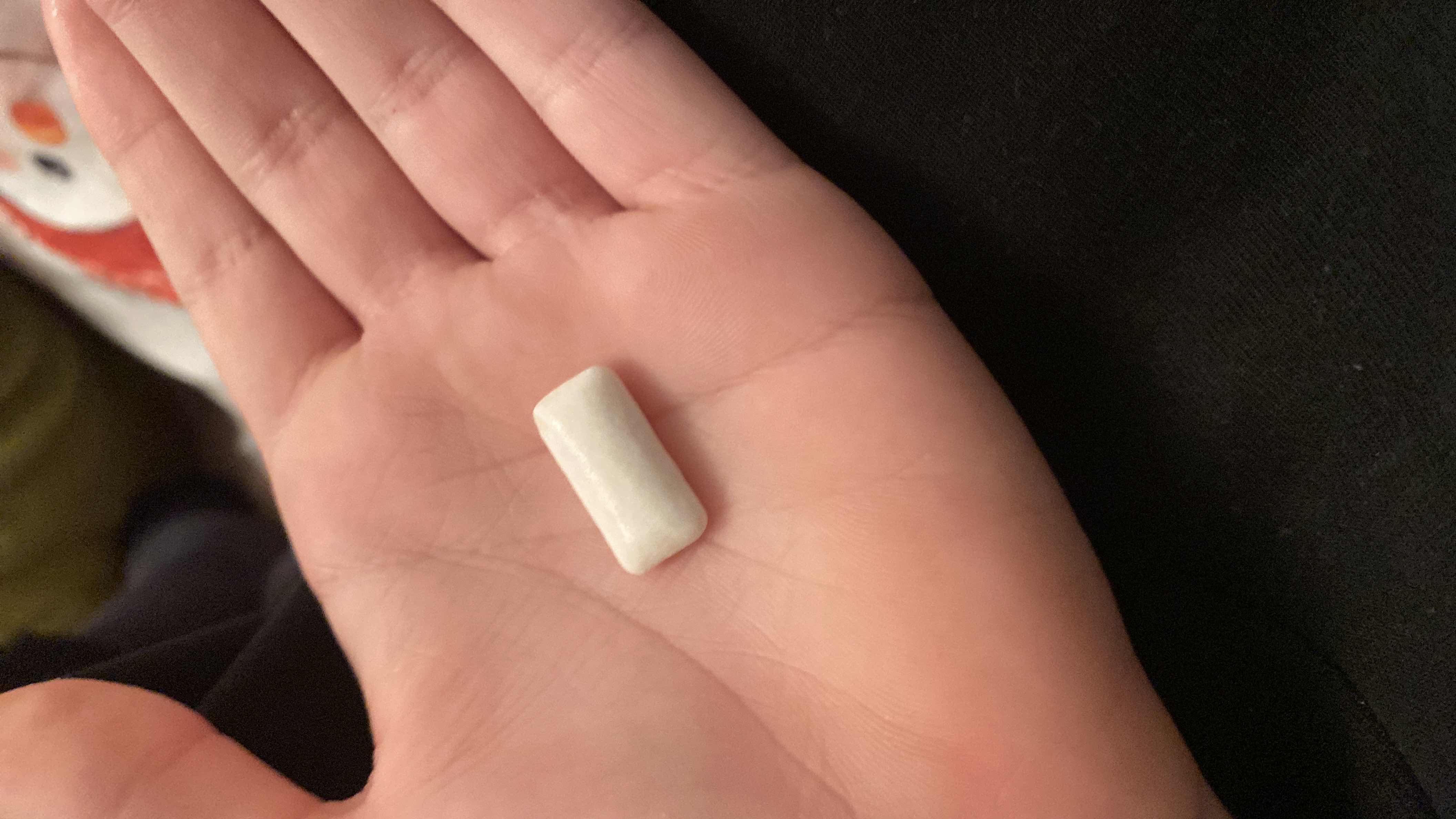 A single piece of chewing gum with minimal calories, primarily composed of carbohydrates.