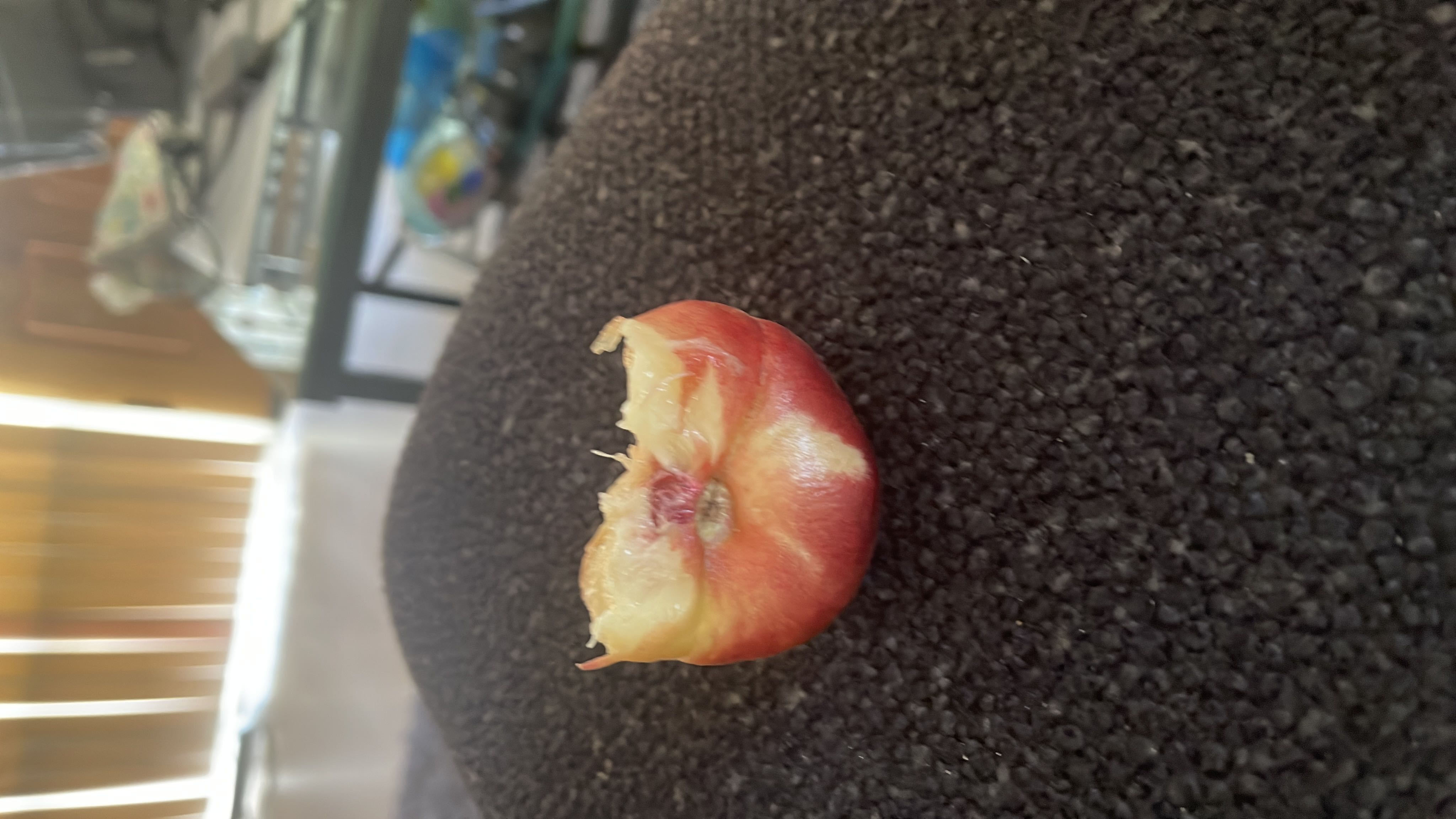 The image shows a partially eaten peach, which is a low-calorie fruit rich in carbohydrates and minimal fats.