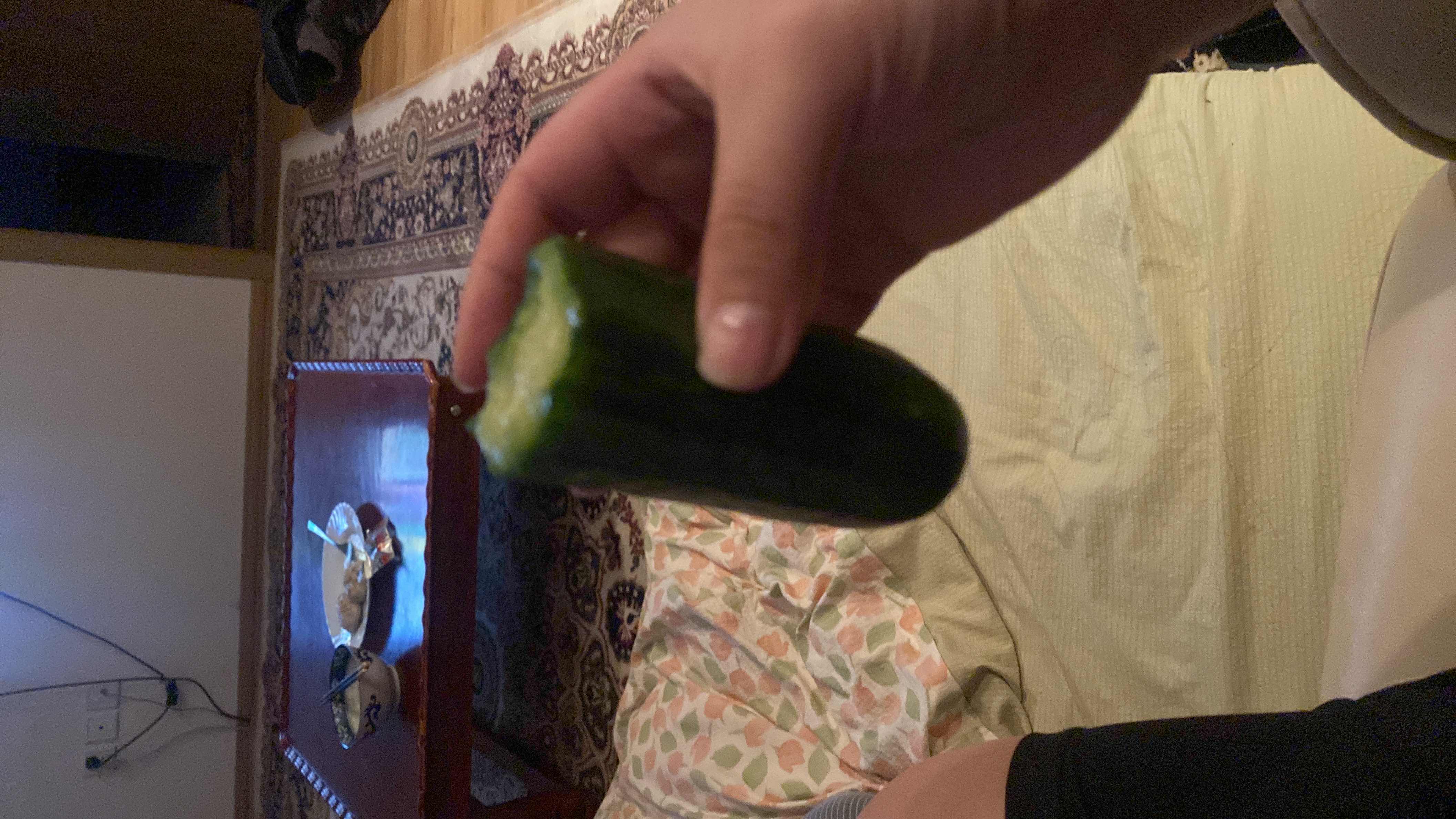 The image shows a cucumber, a low-calorie vegetable with minimal protein, carbs, and no fats, making it a healthy snack option.