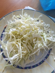 The image shows shredded cabbage, a low-calorie vegetable rich in fiber and nutrients.