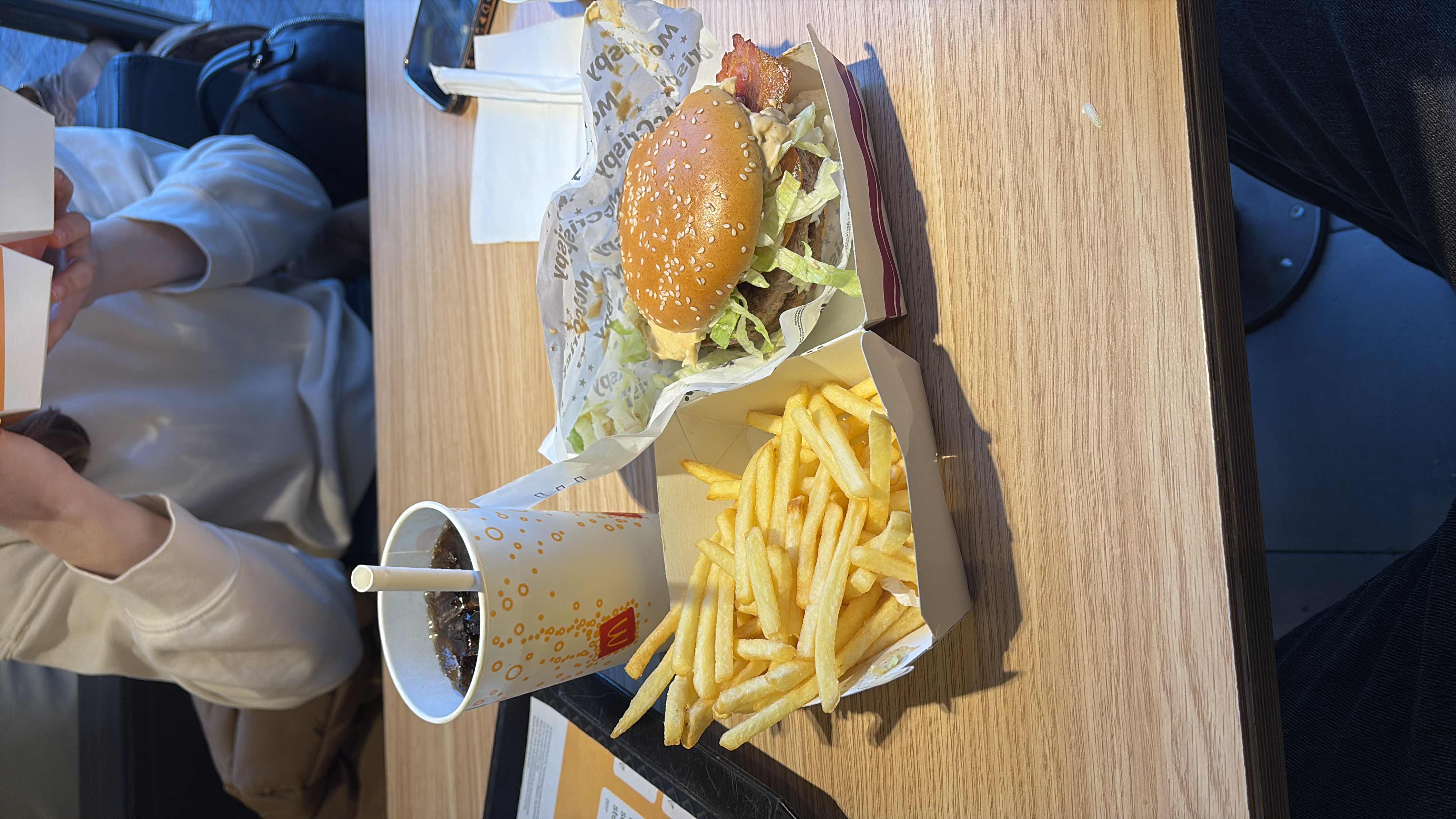 A meal consisting of a burger, fries, and soda, typically high in calories, carbs, and fats.