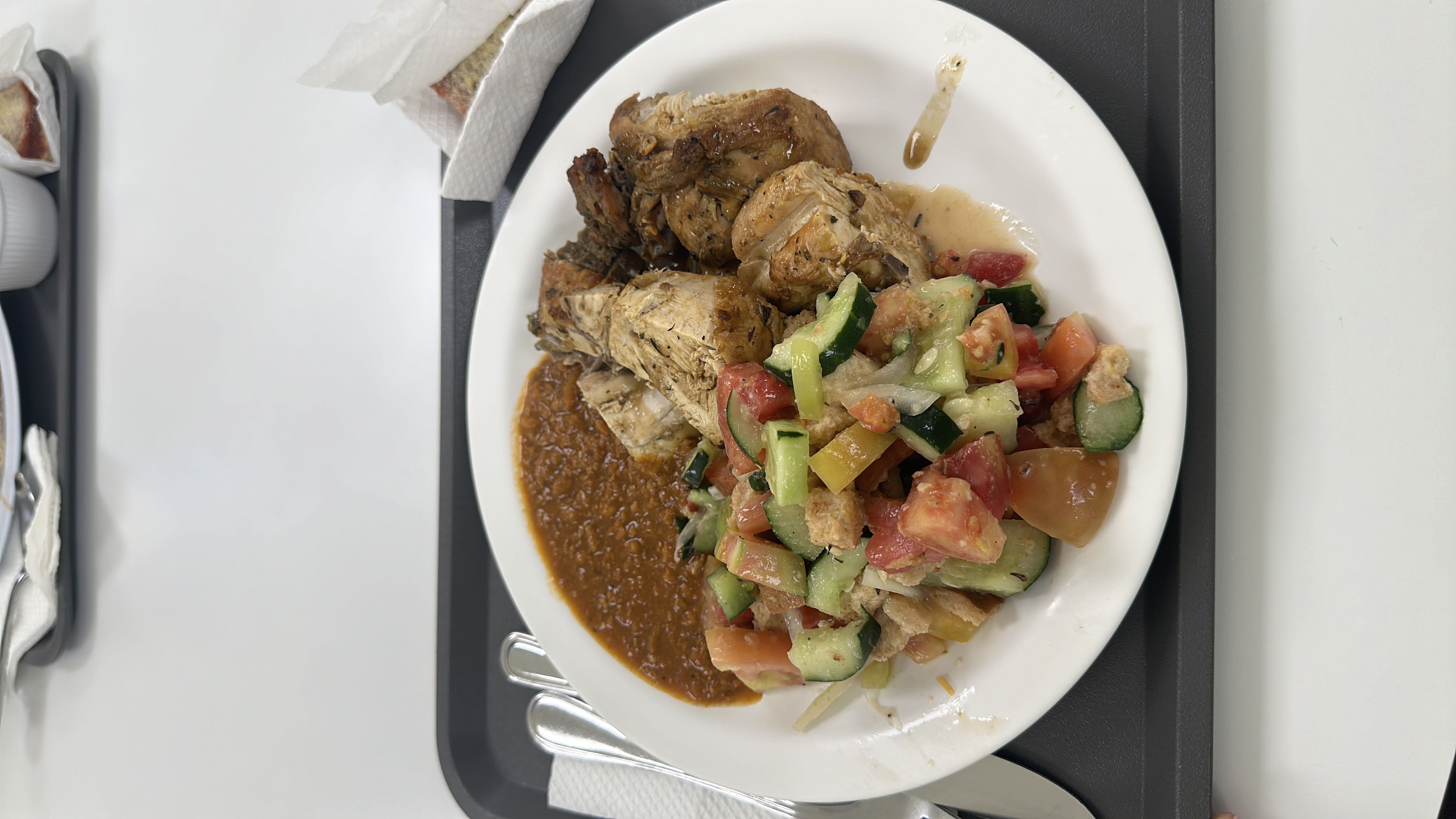 A balanced meal consisting of grilled chicken, a fresh vegetable salad, and lentil stew, providing a good mix of protein, carbs, and fats.
