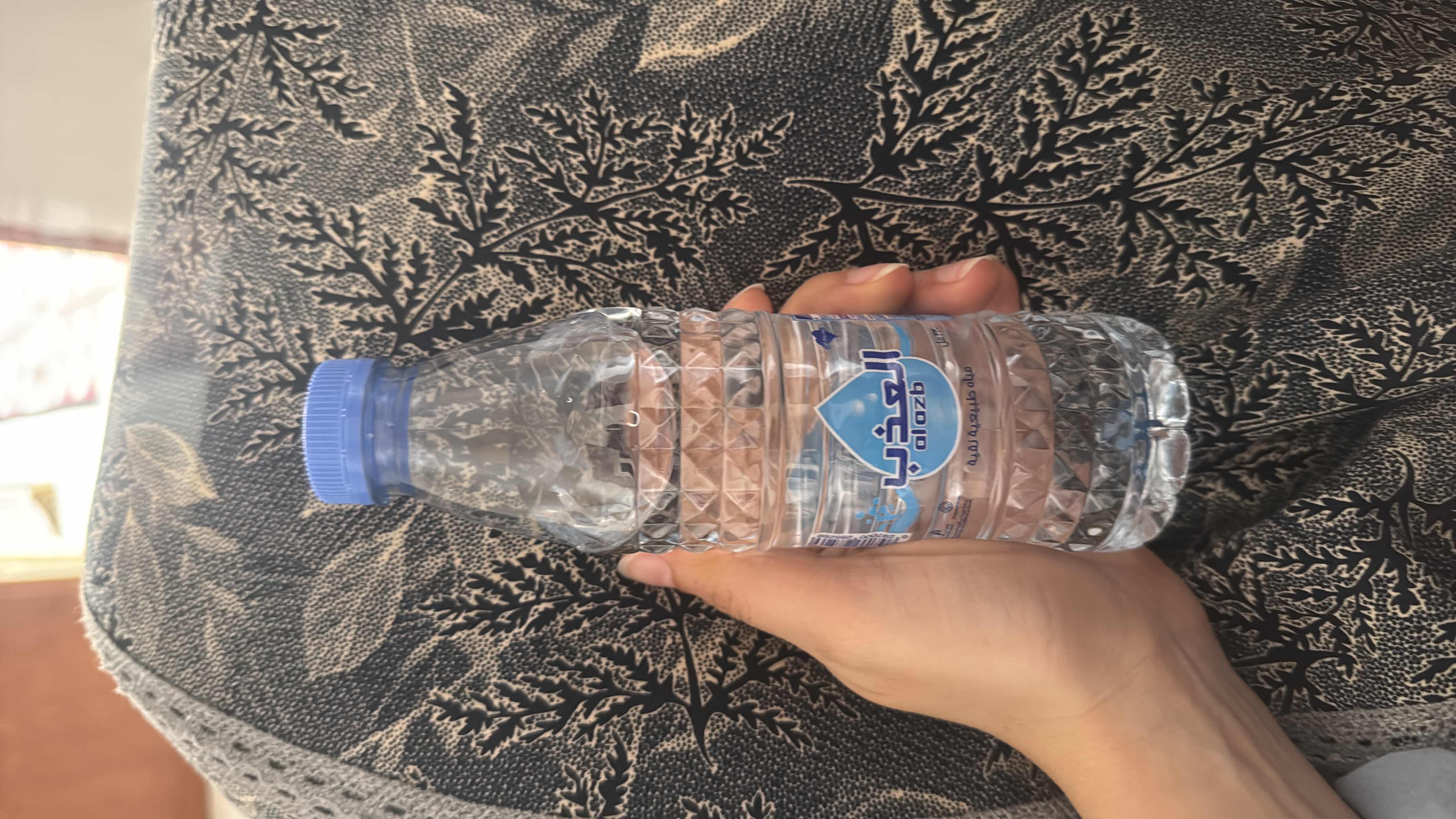 This is a bottle of natural drinking water with no calories, protein, carbs, or fats.