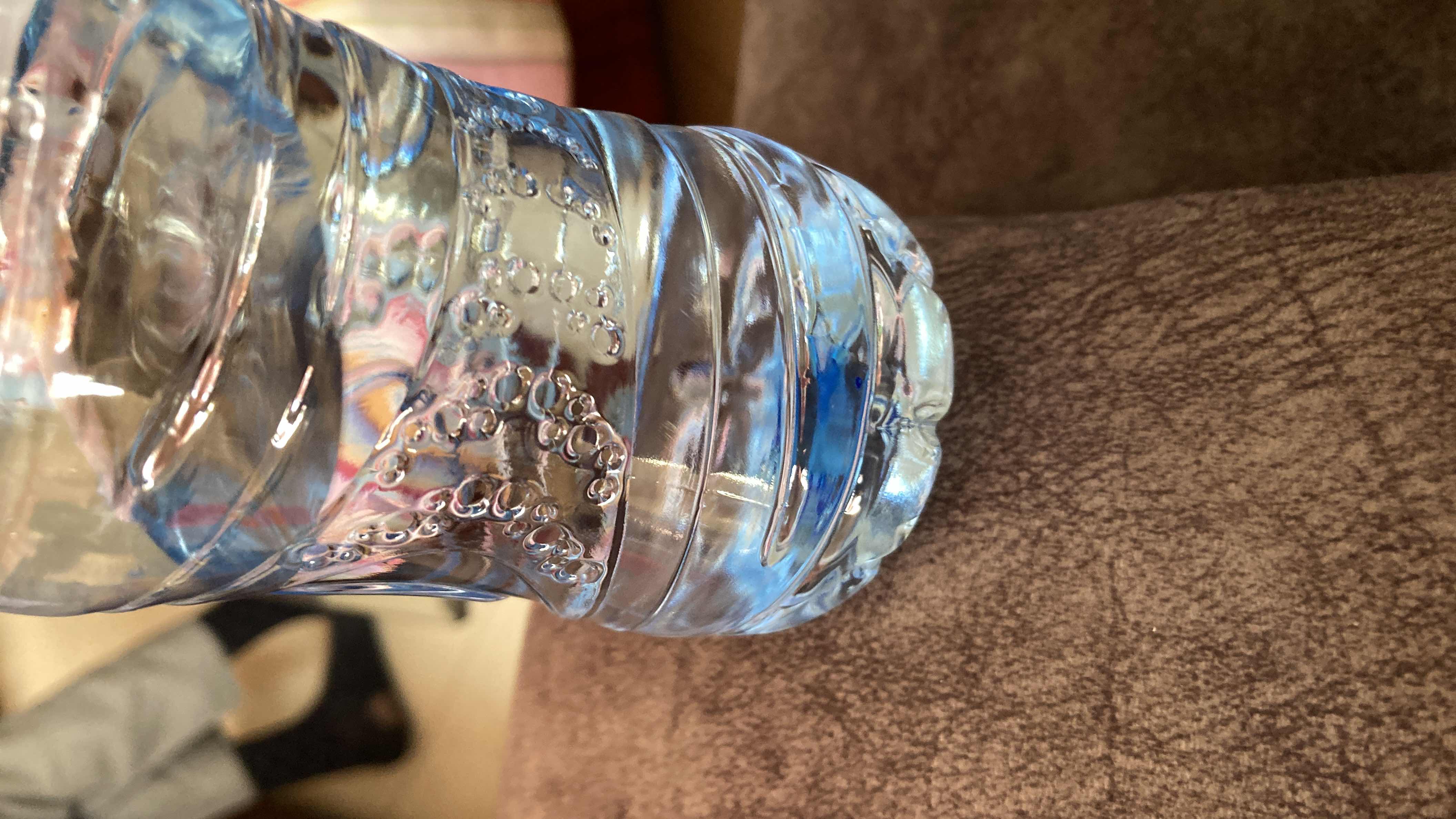 The image shows a bottle of water, which contains no calories, protein, carbs, or fats, making it a highly healthy and hydrating option.