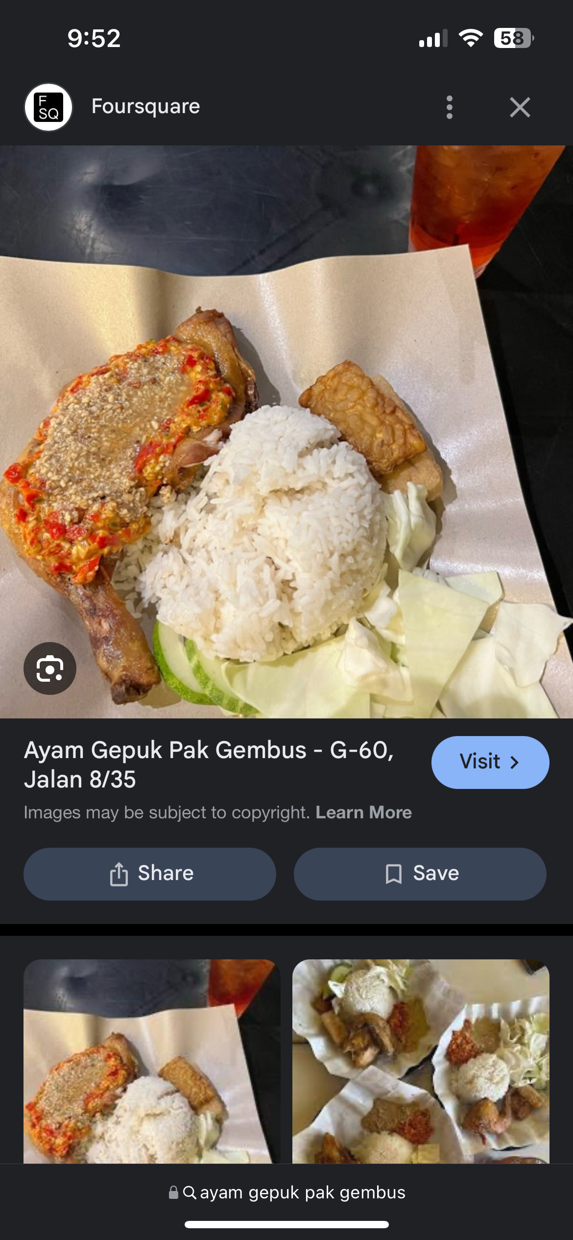 A traditional Indonesian dish featuring fried chicken with chili sauce, steamed rice, tempeh, and fresh vegetables.