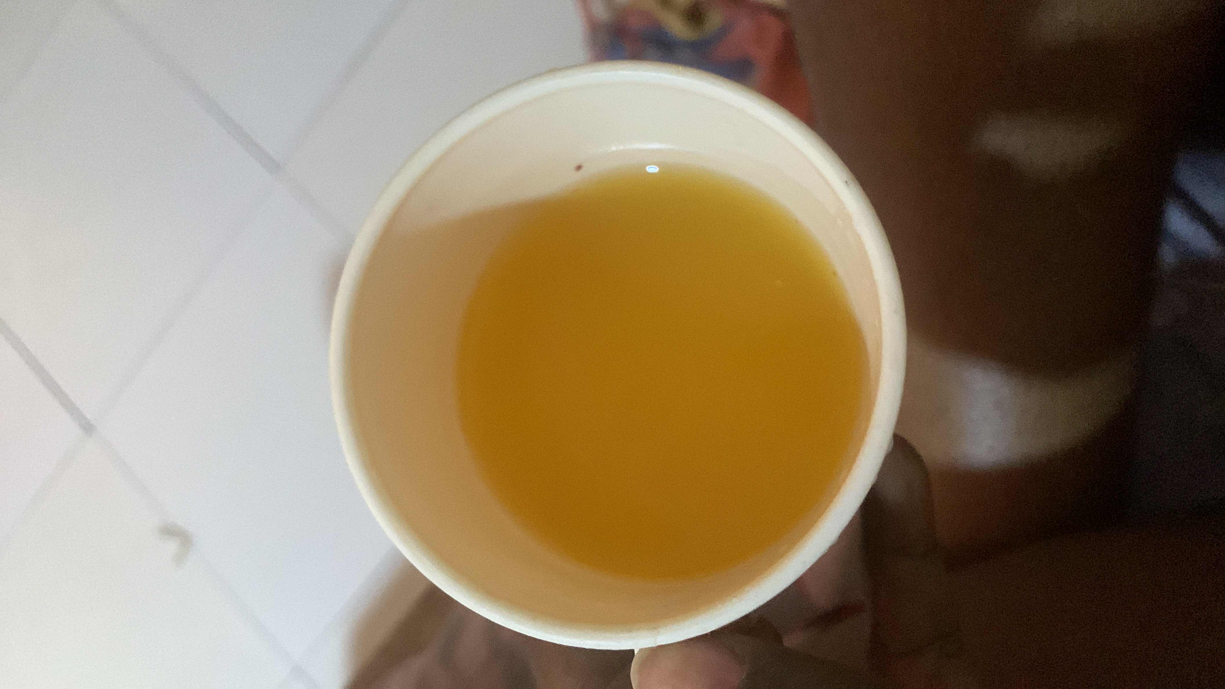 A cup of orange juice, likely fresh, with moderate calories and a good source of carbohydrates.
