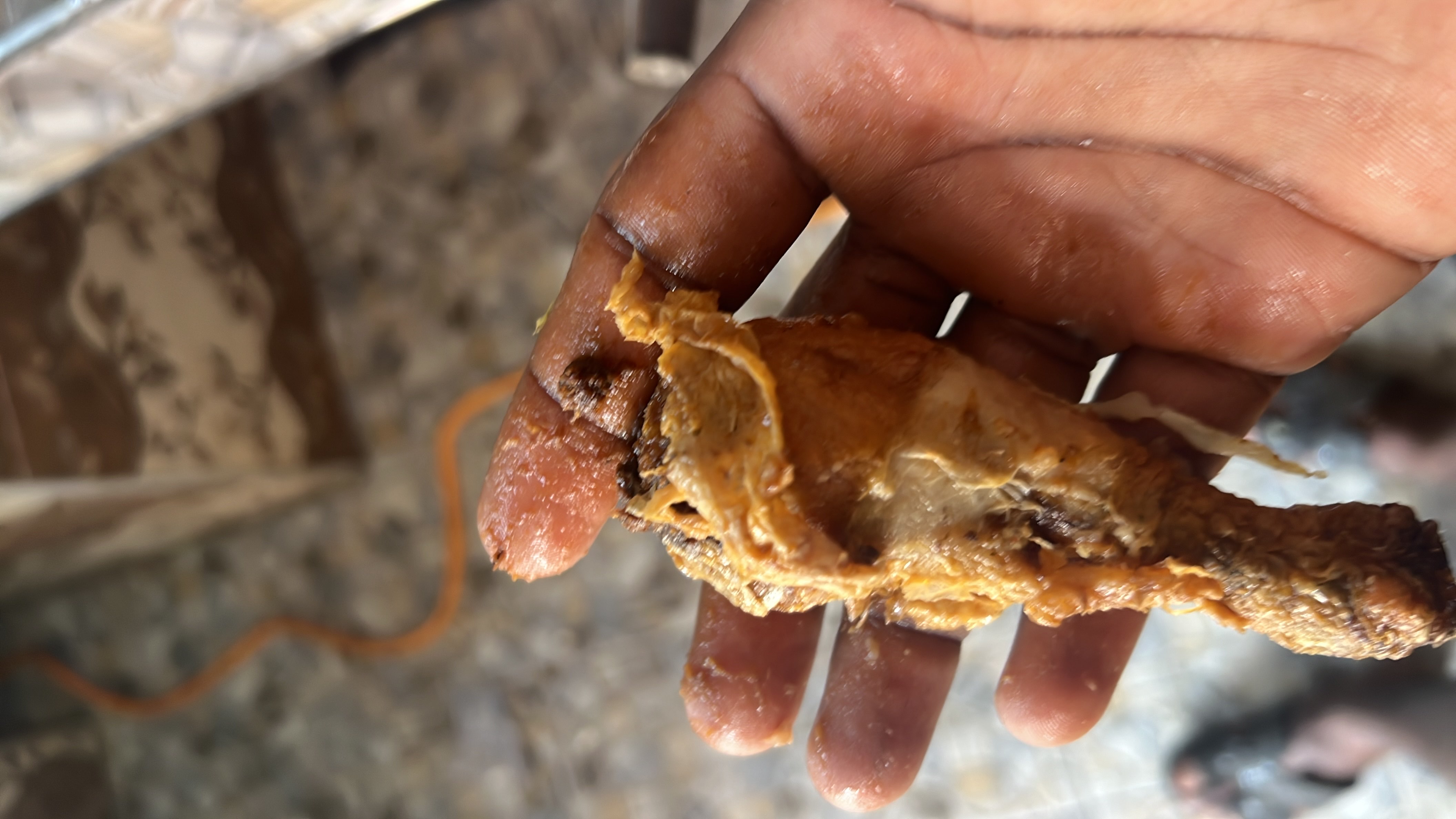 A cooked chicken drumstick, likely fried or roasted, providing a good source of protein with moderate fat content.