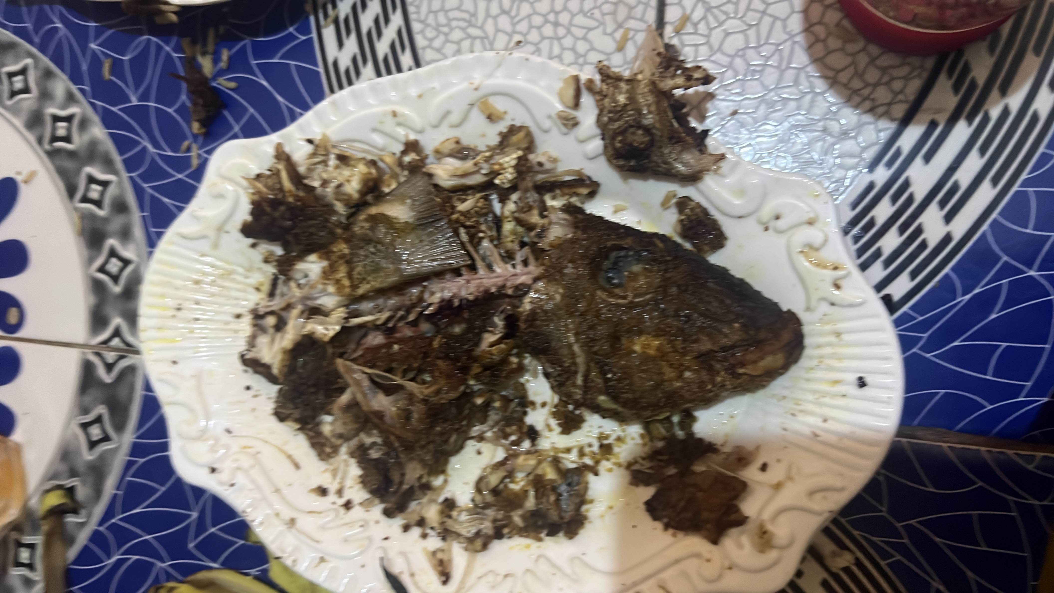 The image shows a plate of cooked fish, which is a high-protein, low-carb dish with moderate fat content.