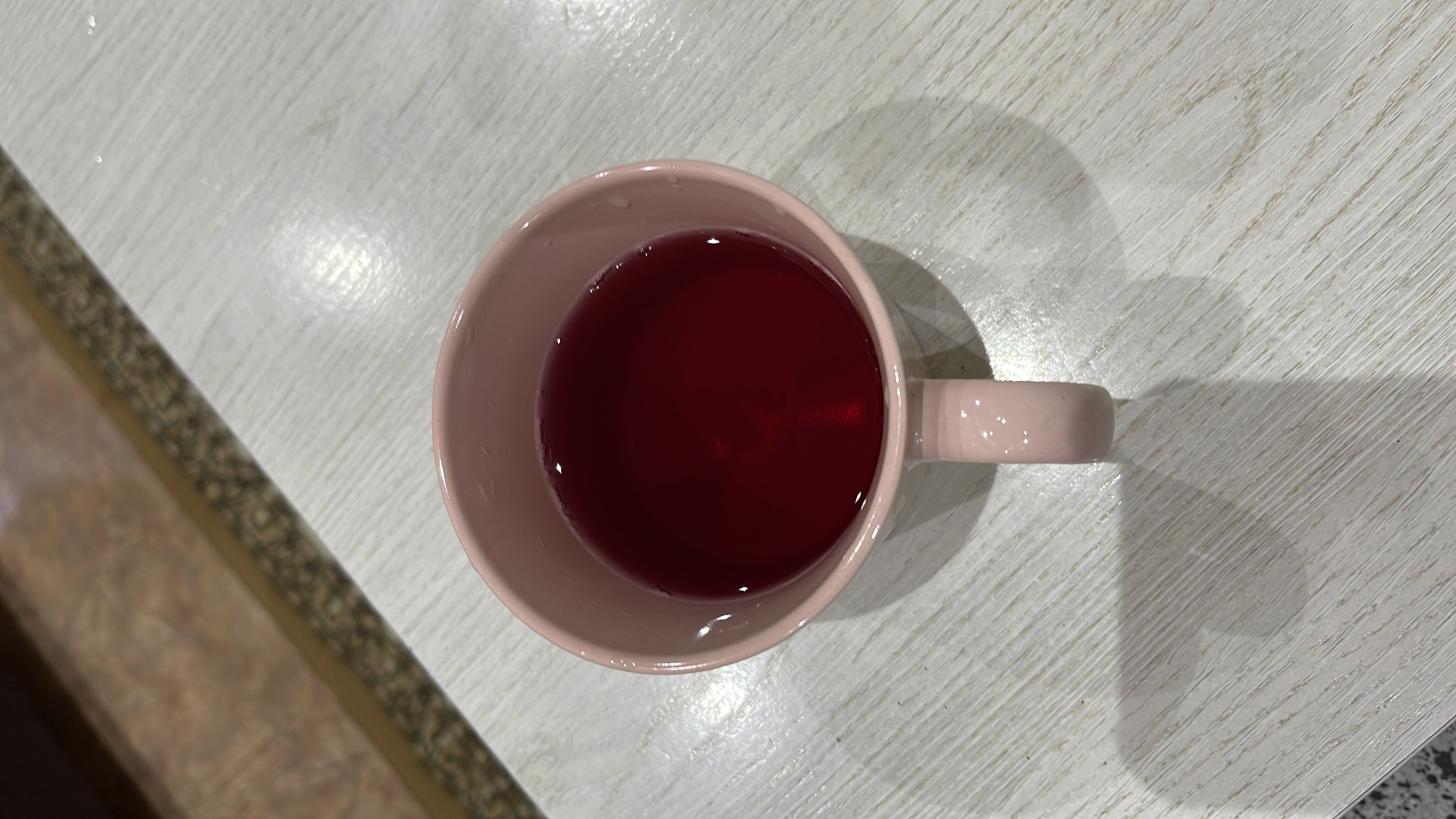 A cup of hibiscus tea, a low-calorie beverage with minimal carbs and no fats or protein.