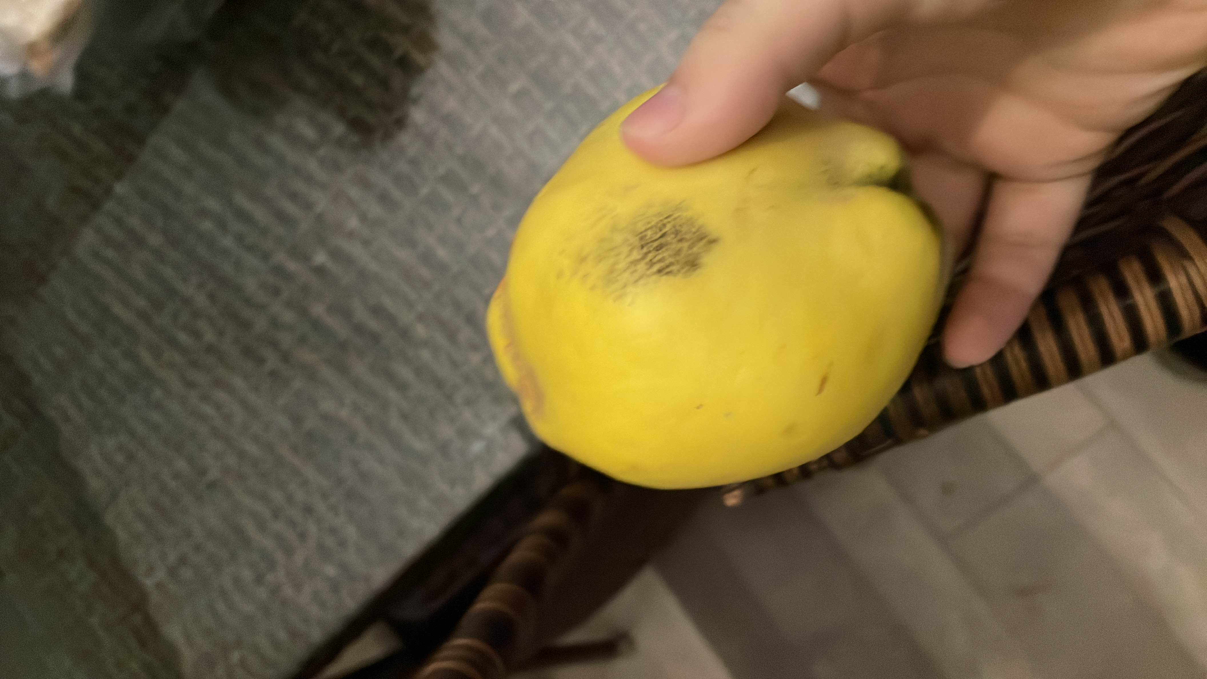 The image shows a quince, a fruit that is low in calories and fats, with moderate carbohydrates and a good health score.