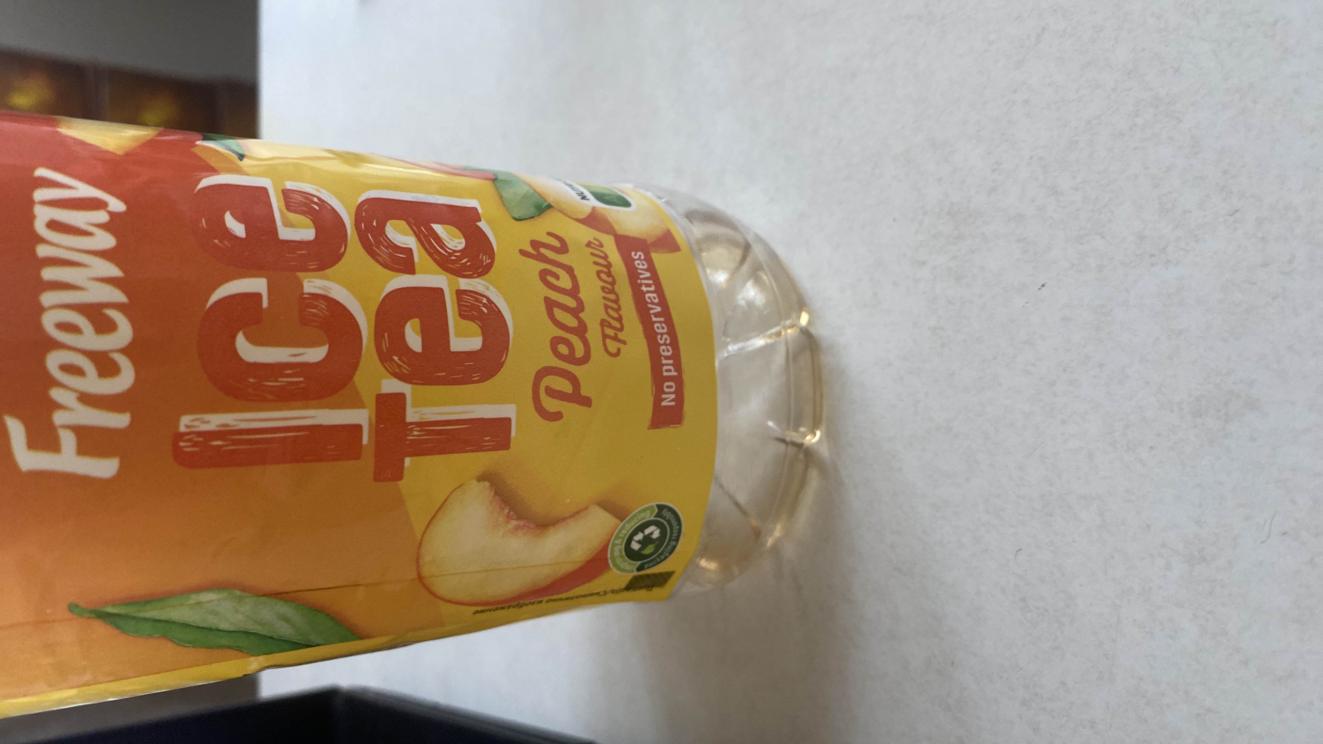 A peach-flavored iced tea with no preservatives, low in calories, and primarily composed of carbohydrates.
