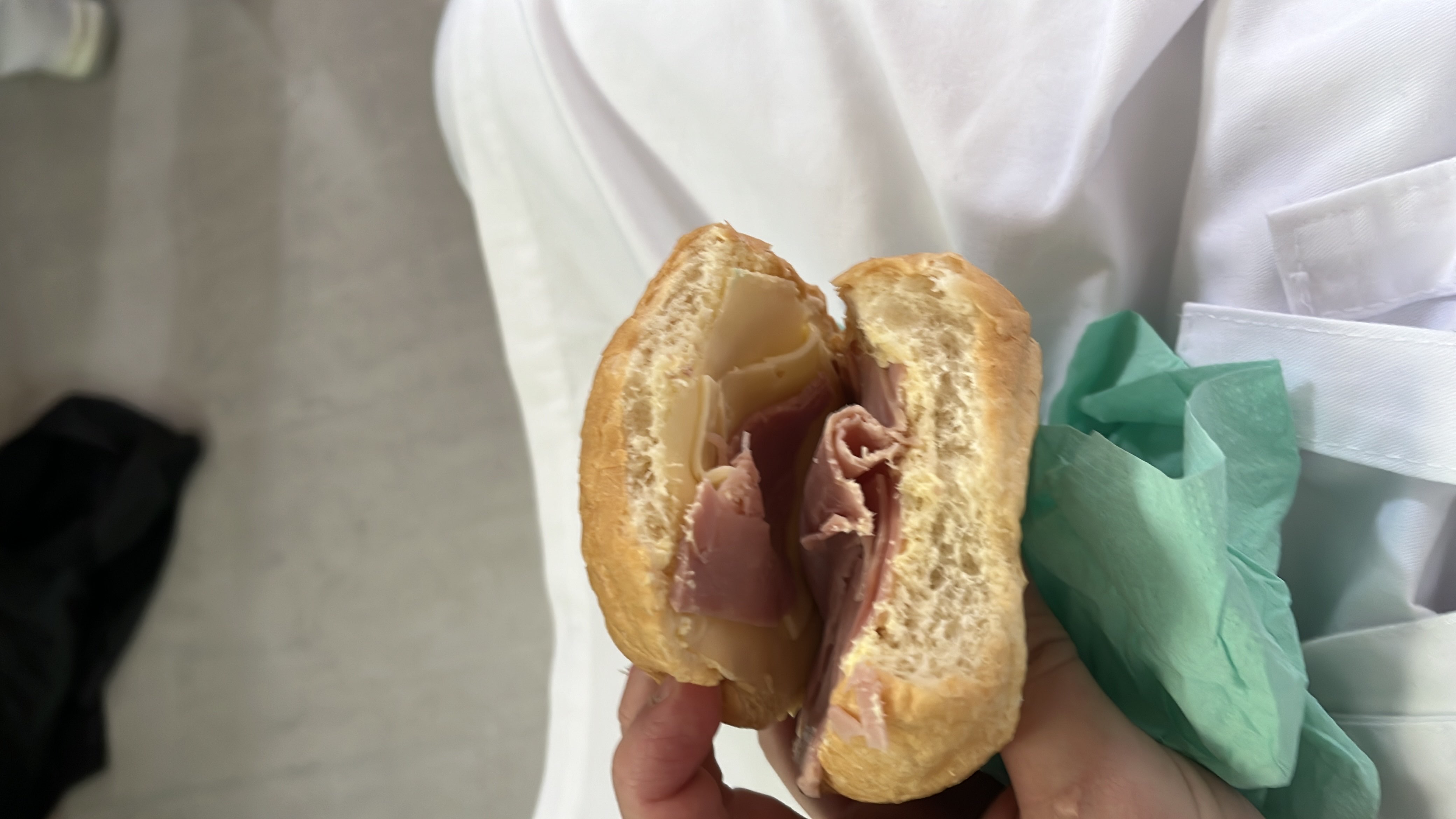 A ham and cheese sandwich made with a bread roll, containing moderate calories and a balanced mix of protein, carbs, and fats.
