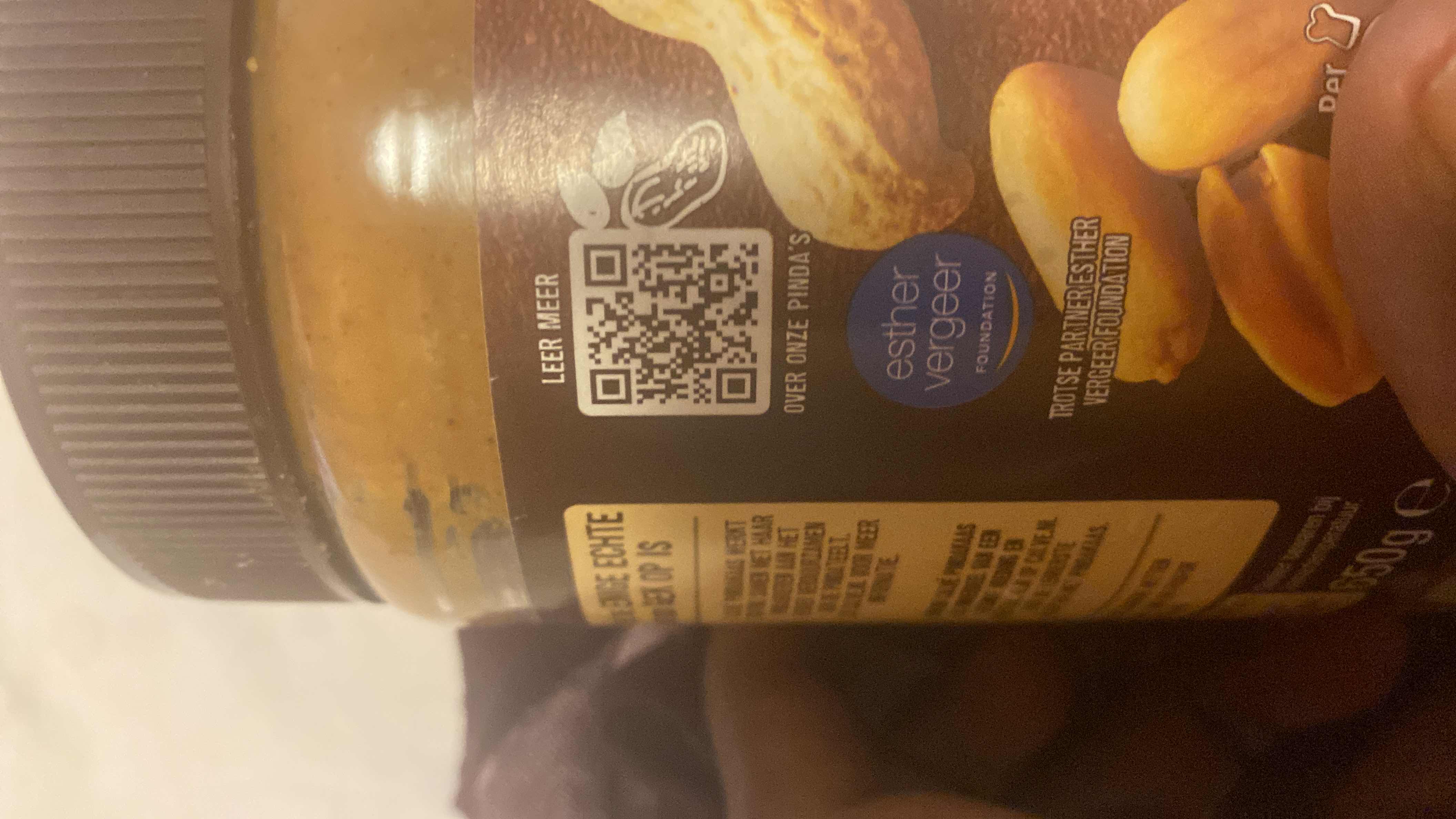 The image shows a peanut butter jar with branding and a QR code, but no clear nutritional information is visible.