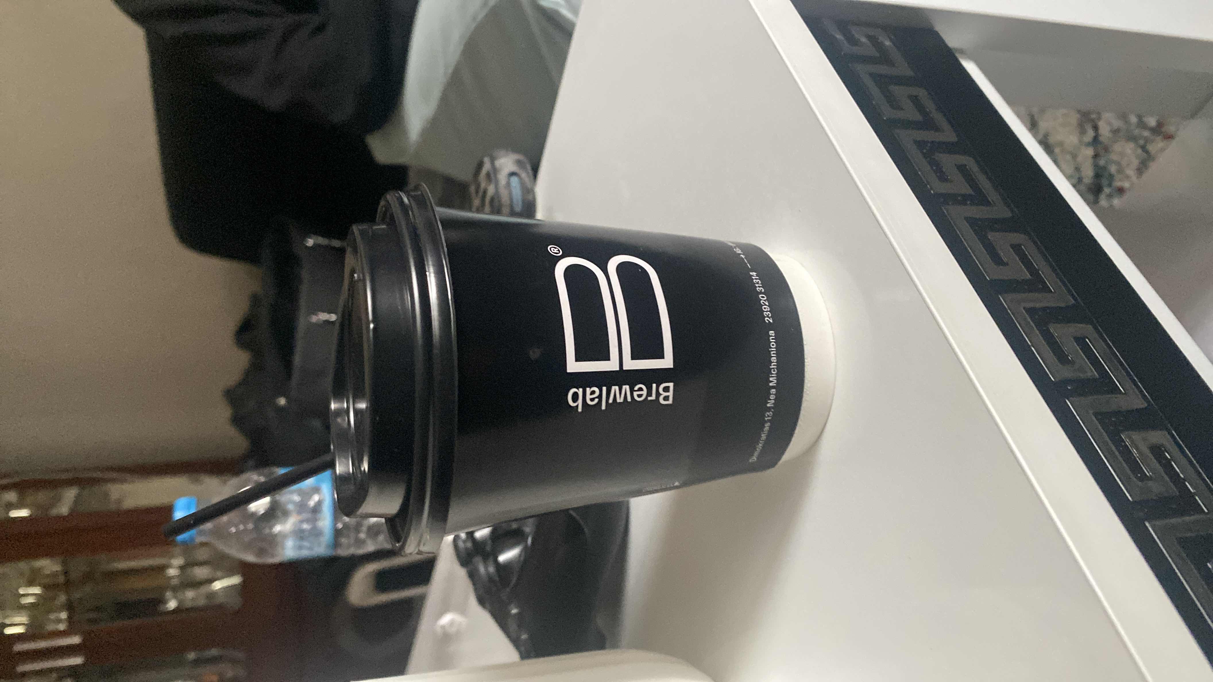 A cup of black coffee from Brewlab, likely containing no significant calories, protein, carbs, or fats.