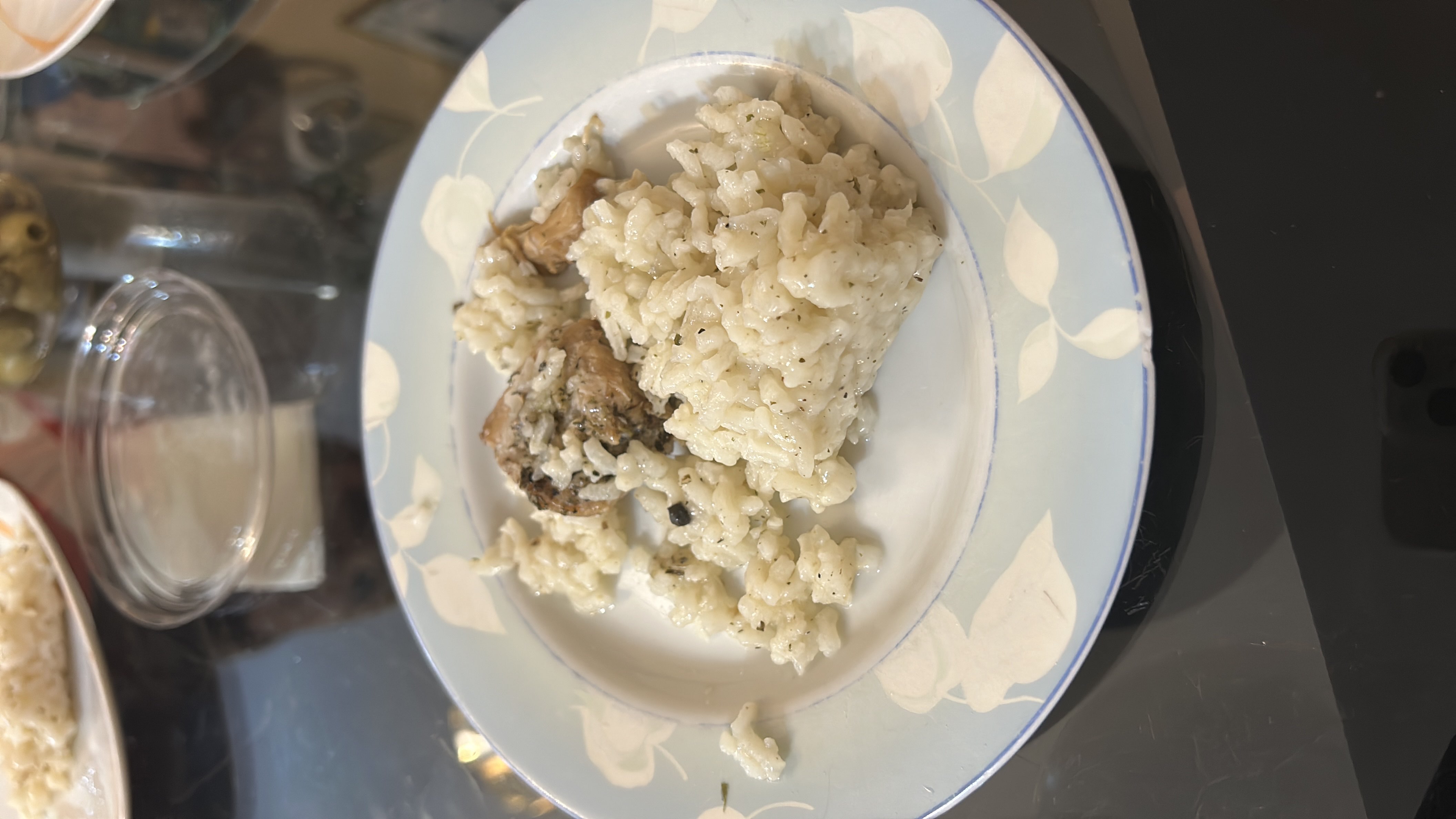 A plate of seasoned rice with a piece of chicken, providing a balanced mix of protein, carbs, and fats.