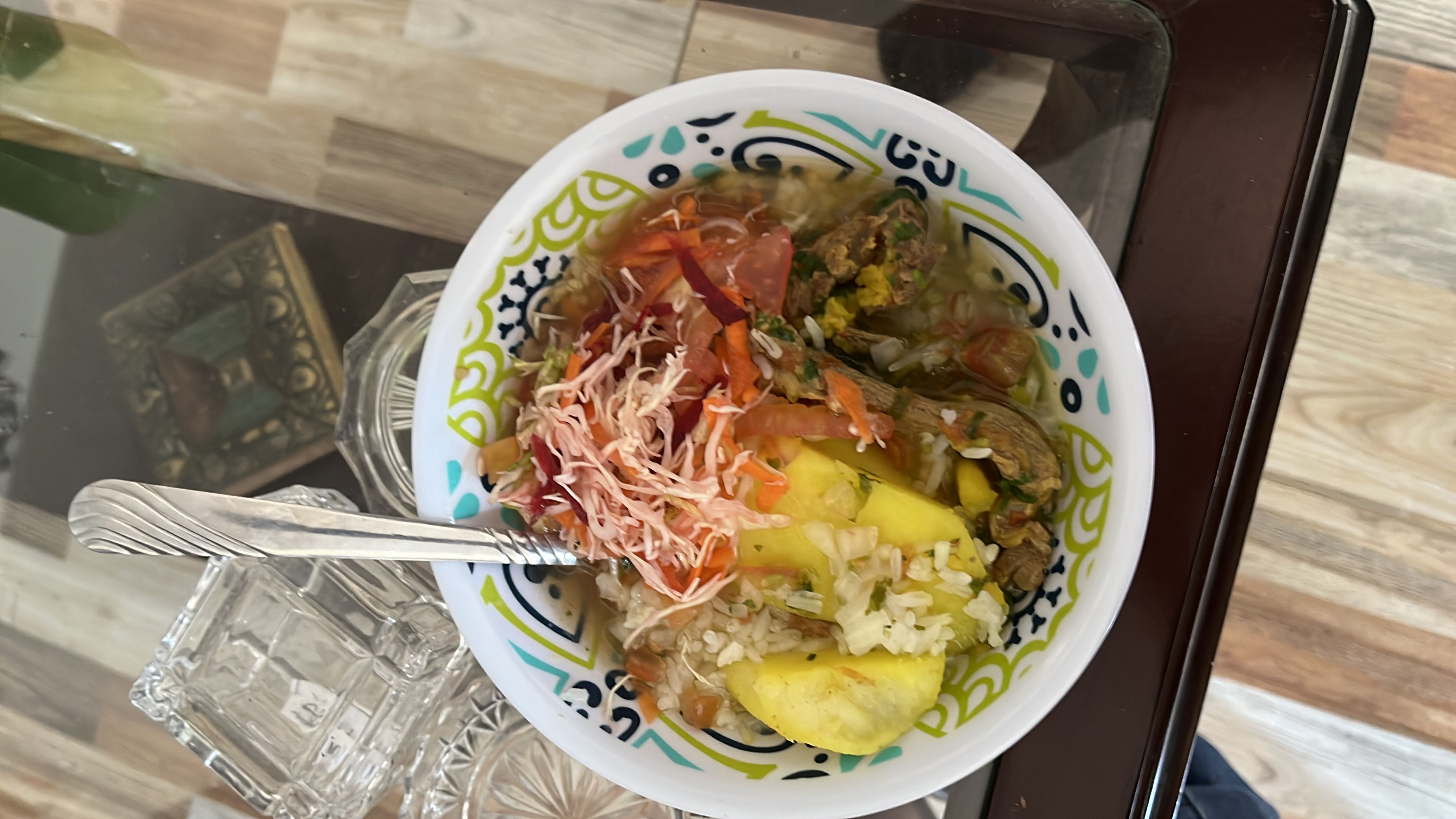 A balanced meal consisting of rice, potatoes, vegetables, and meat, providing a good mix of protein, carbs, and fats.