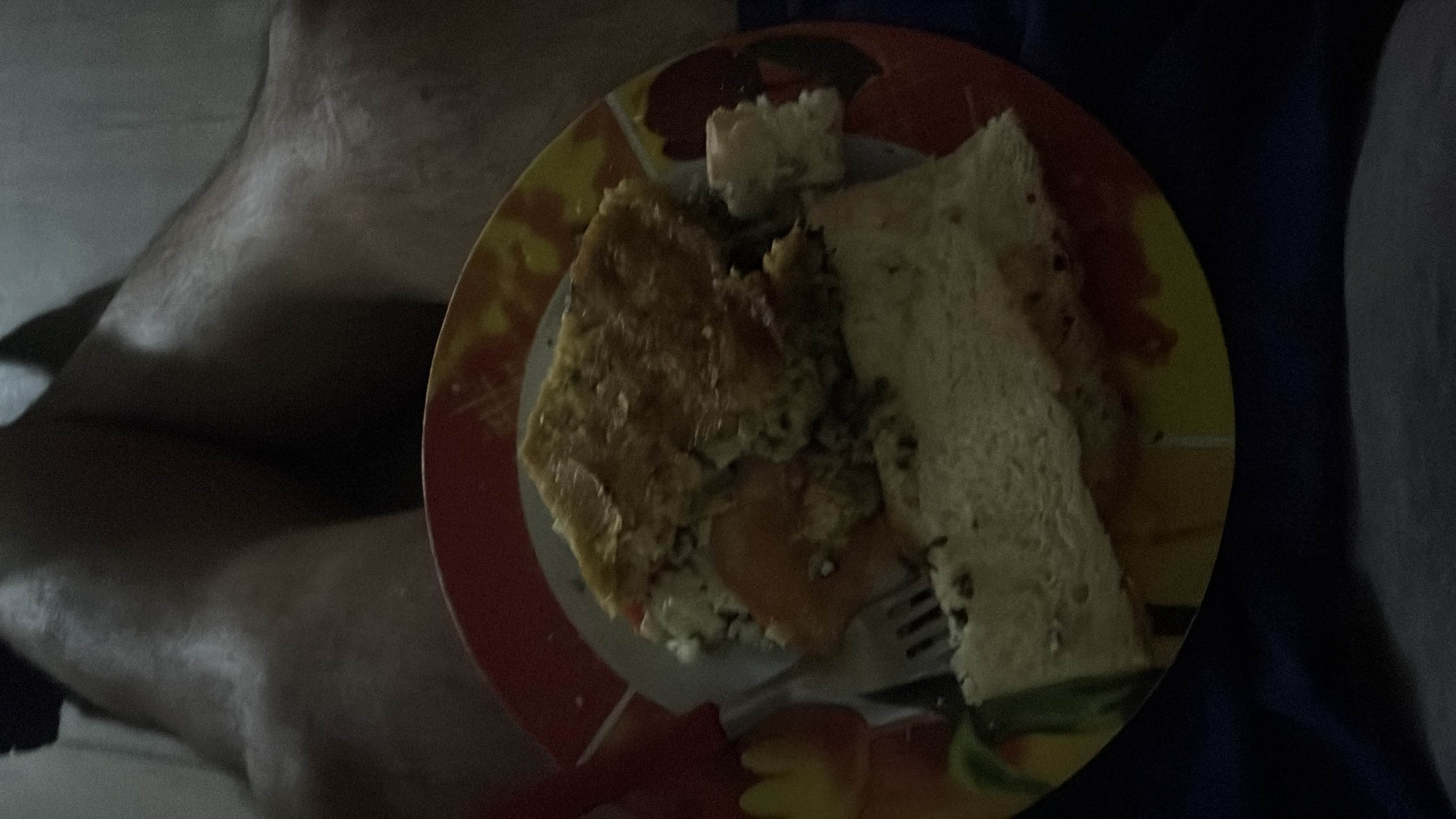 A plate containing a slice of bread and an omelette, providing a balanced mix of carbs, protein, and fats.