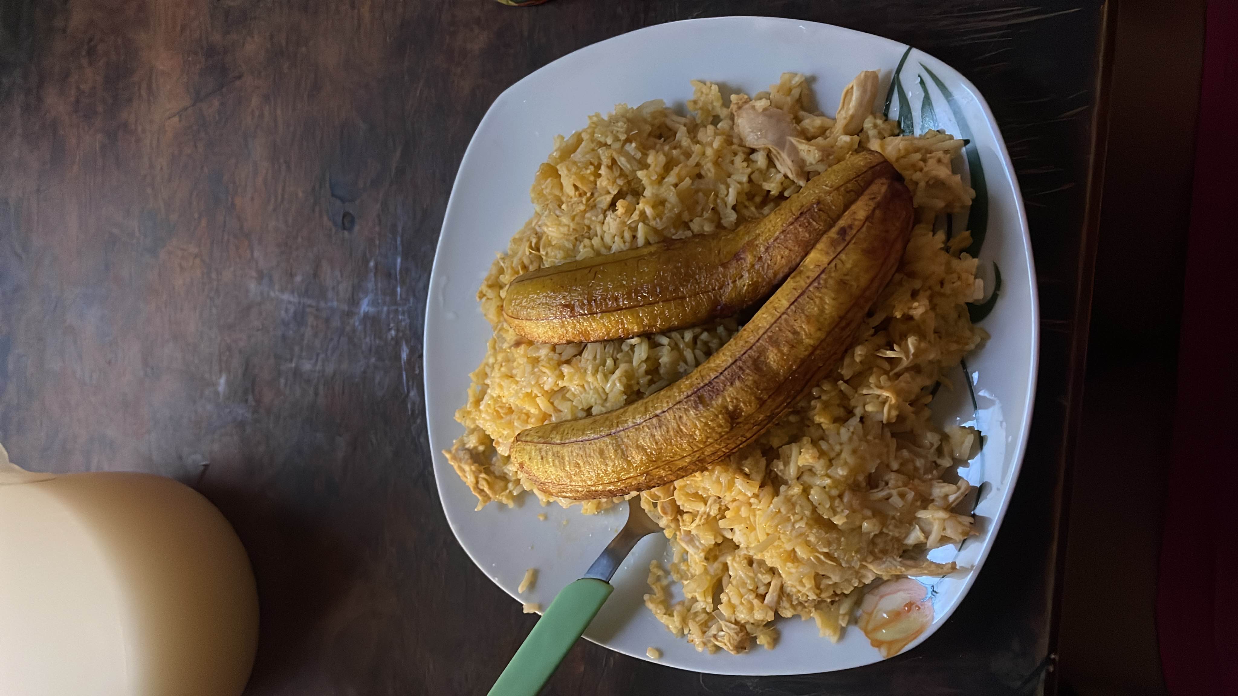A dish consisting of rice, fried plantains, and shredded chicken, providing a balanced mix of carbohydrates, protein, and fats.