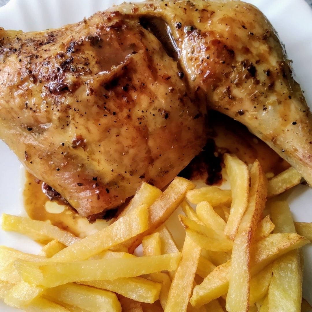 A dish consisting of roasted chicken leg served with golden french fries, providing a balanced mix of protein, fats, and carbohydrates.