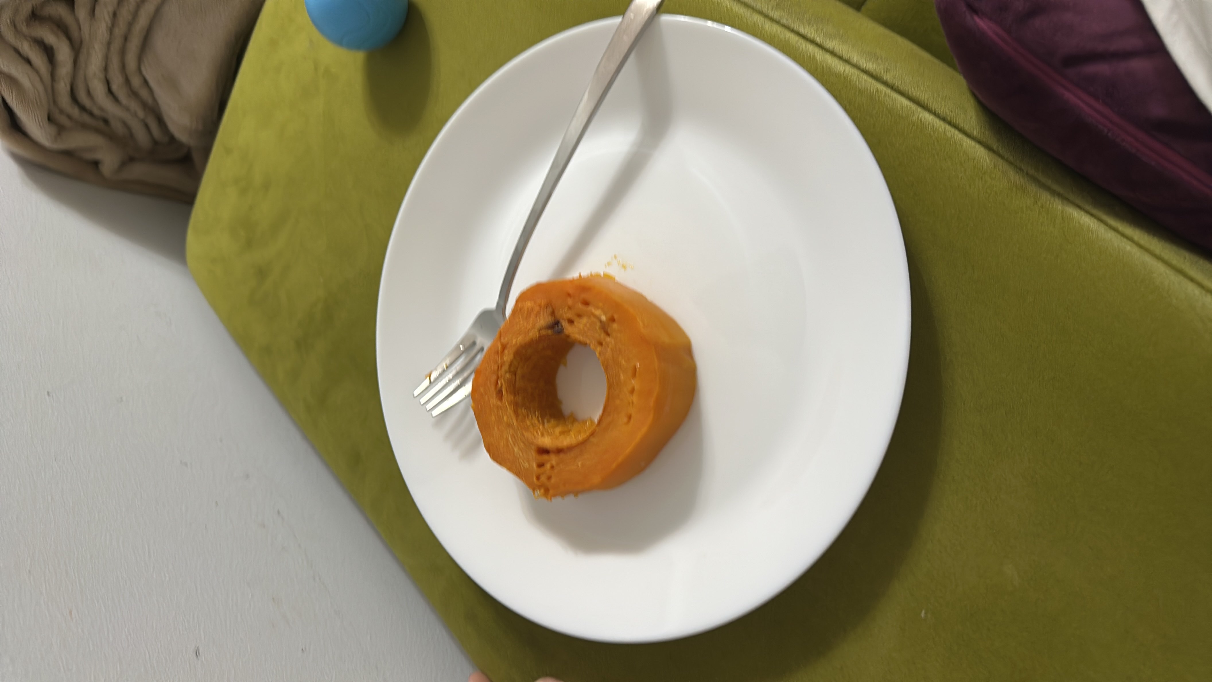 A single slice of cooked pumpkin served on a white plate, providing a low-calorie, nutrient-rich option with no added sugar or sweeteners.