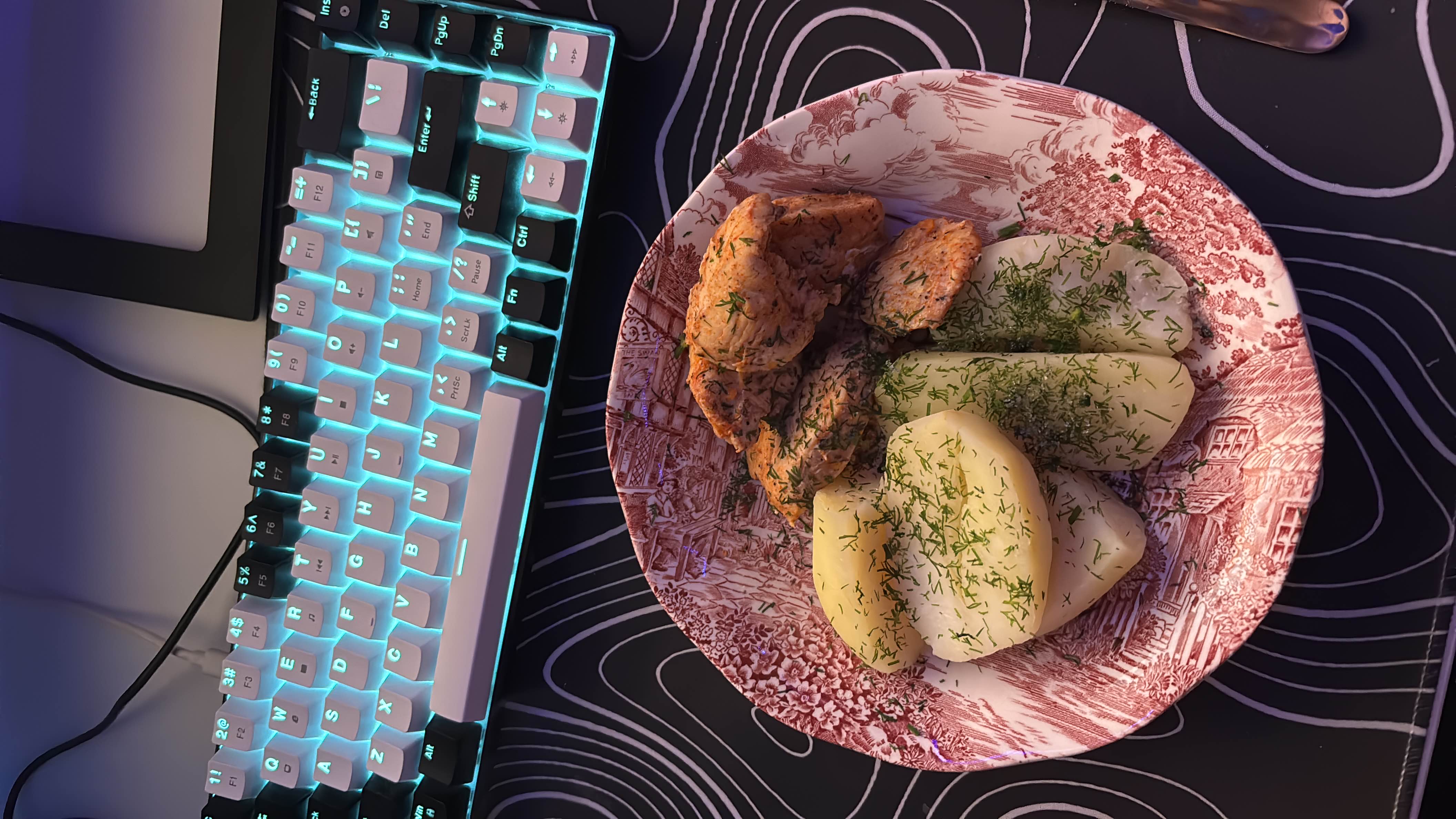 A plate of boiled potatoes garnished with dill and served with seasoned salmon, providing a balanced meal rich in protein and moderate in carbs.