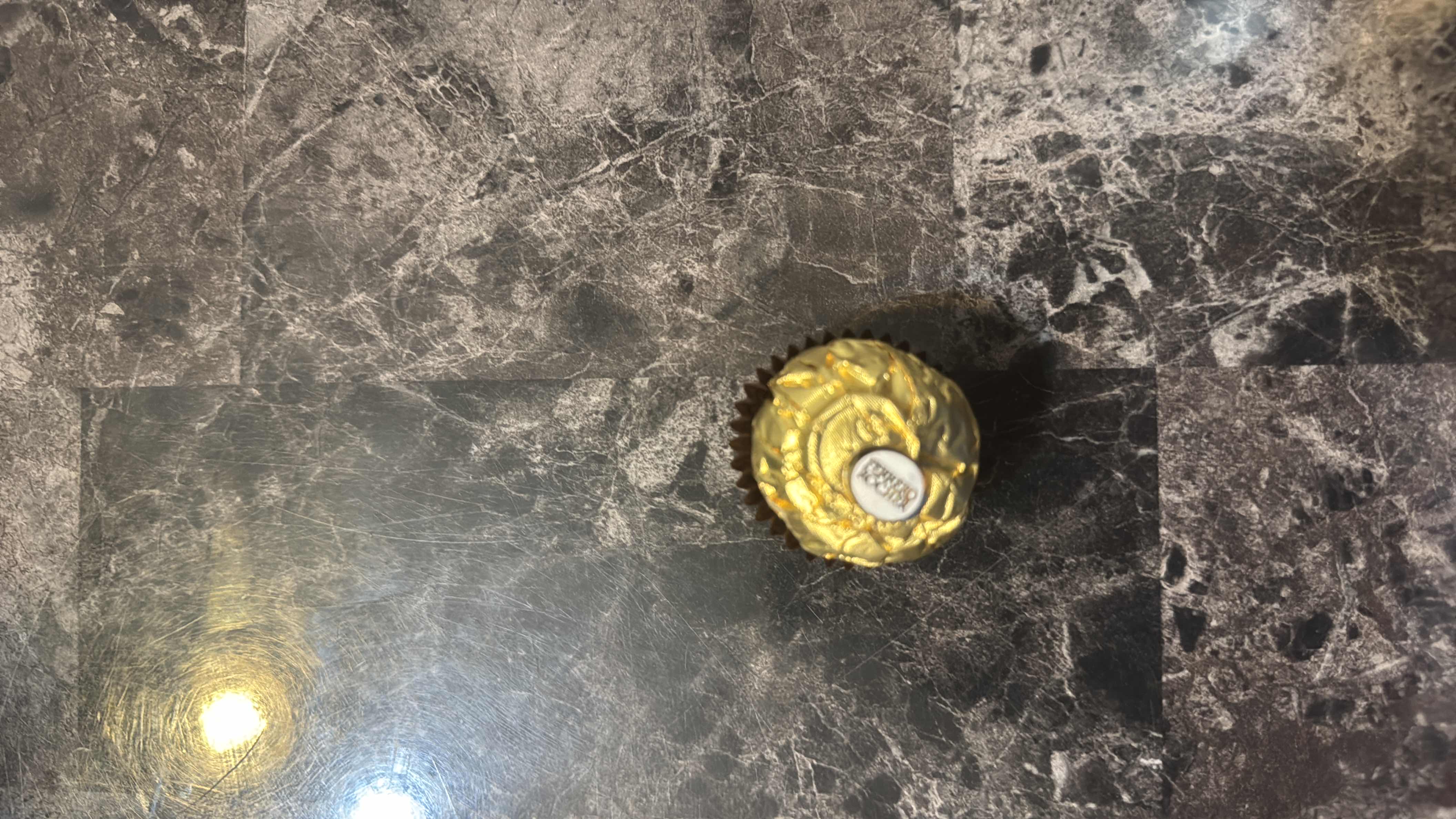 A single Ferrero Rocher chocolate, containing hazelnut, chocolate, and wafer, with a moderate calorie count and balanced nutritional profile.