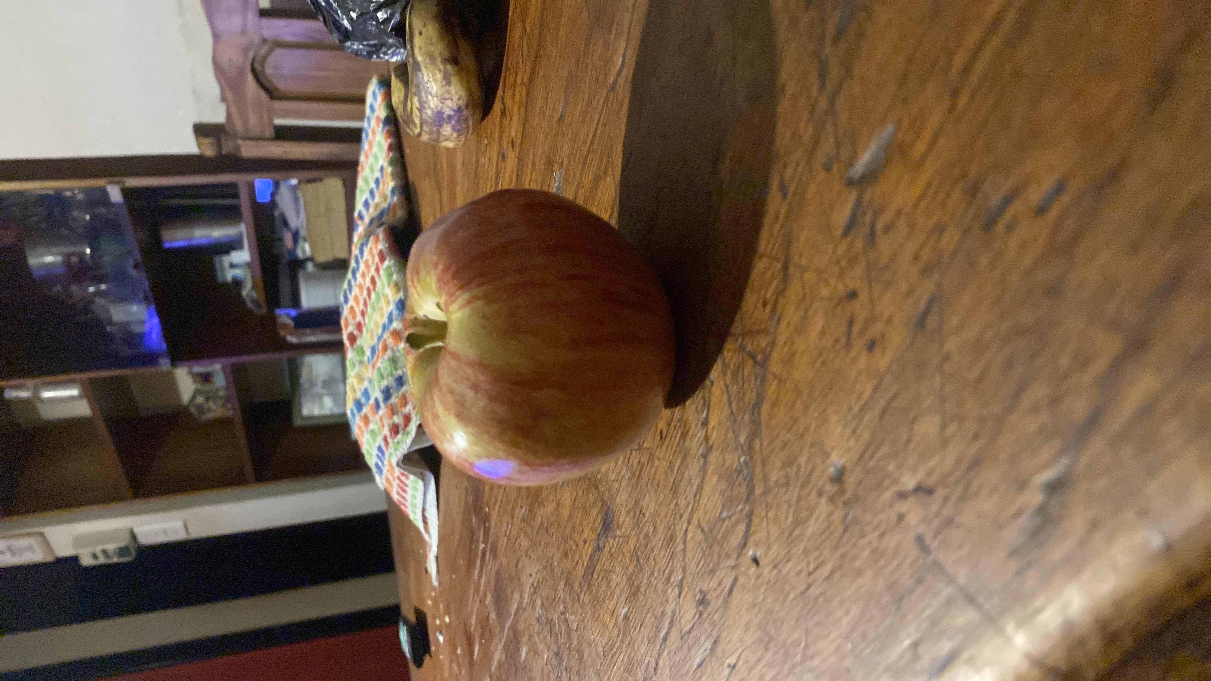 The image shows an apple, which is a nutritious fruit rich in carbohydrates and low in fats and protein.