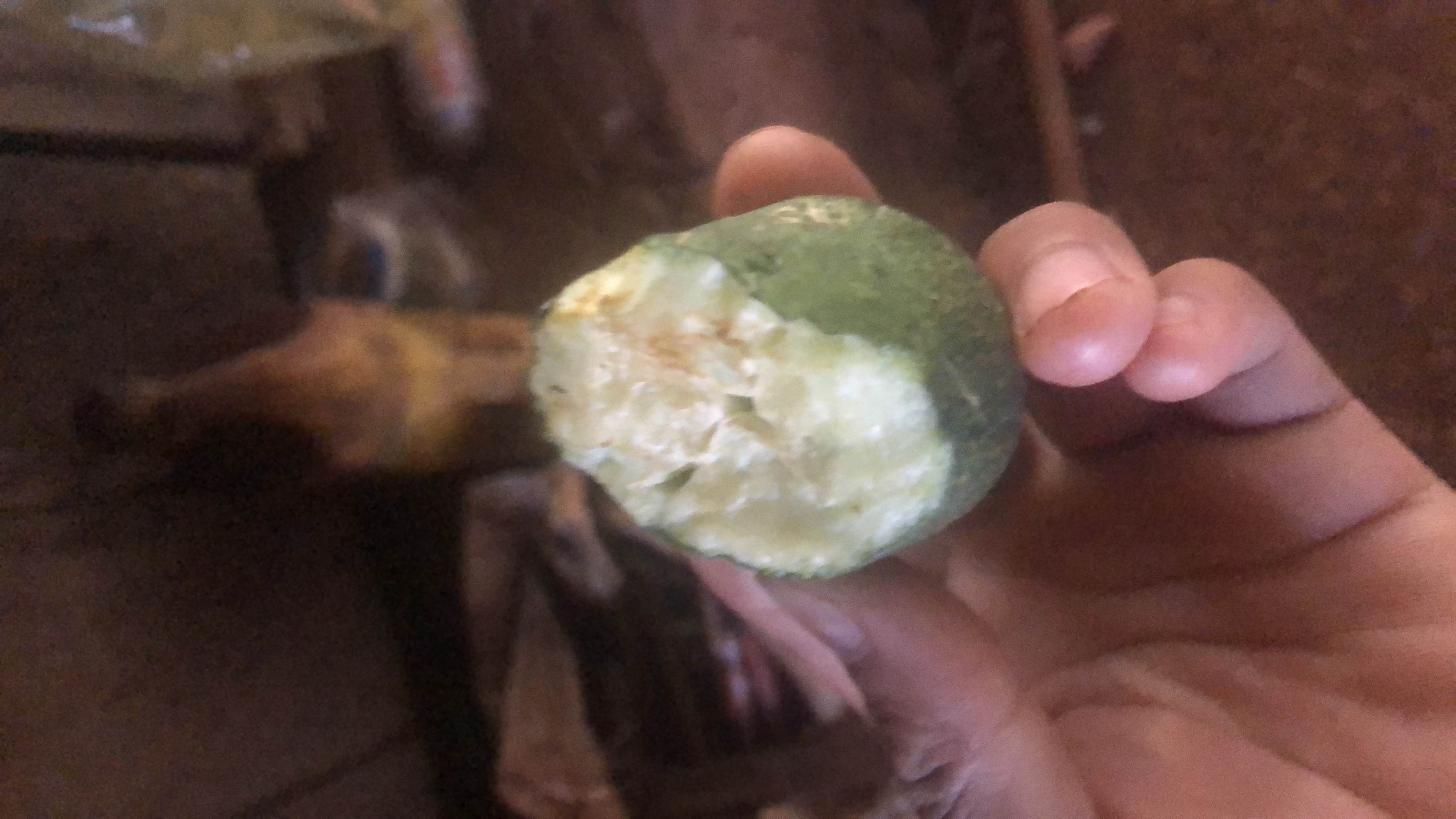 The image shows a partially eaten guava, a fruit known for its moderate calorie content and high nutritional value.
