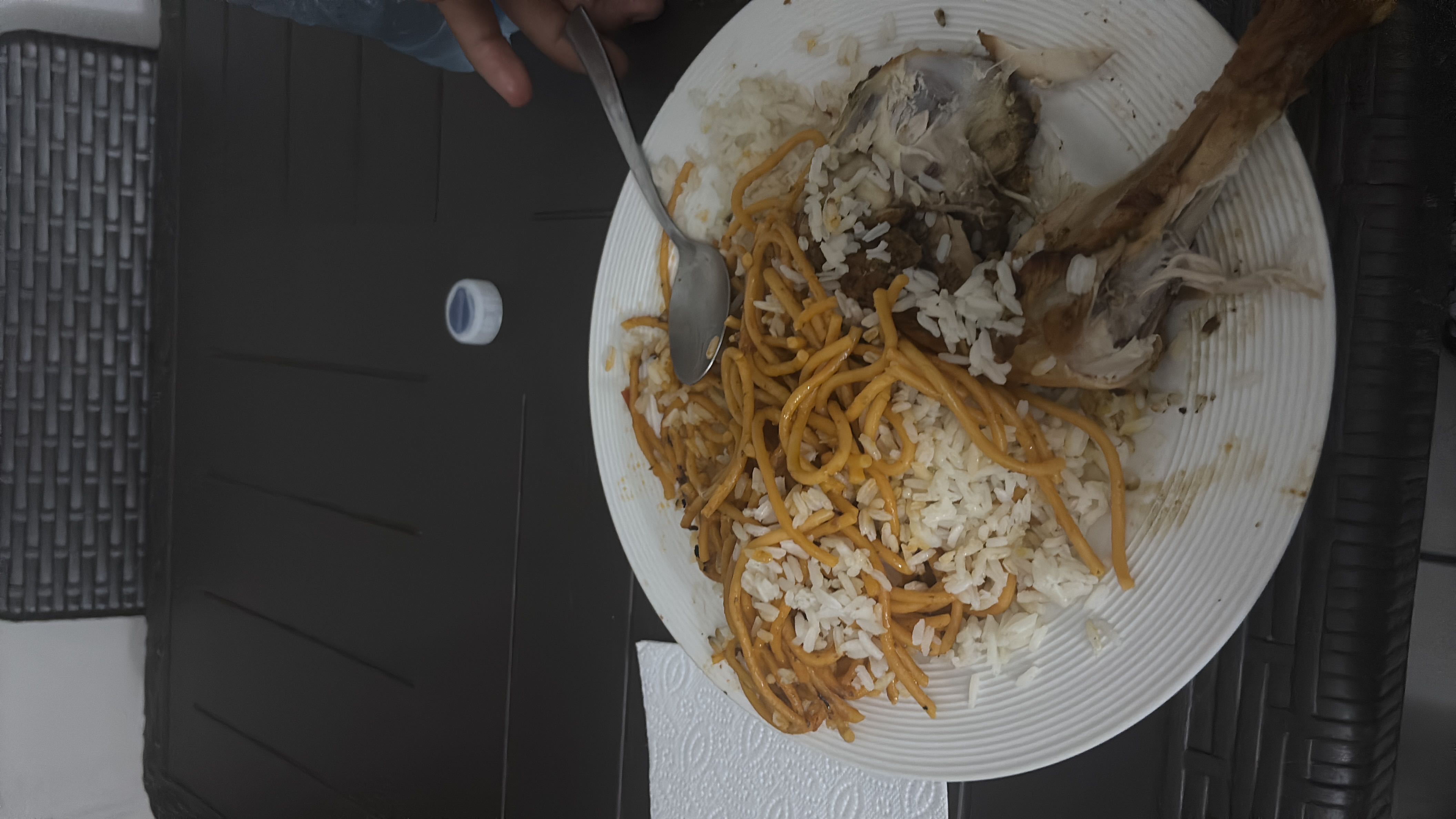 A plate containing rice, noodles, and chicken, providing a balanced mix of carbohydrates, protein, and fats.