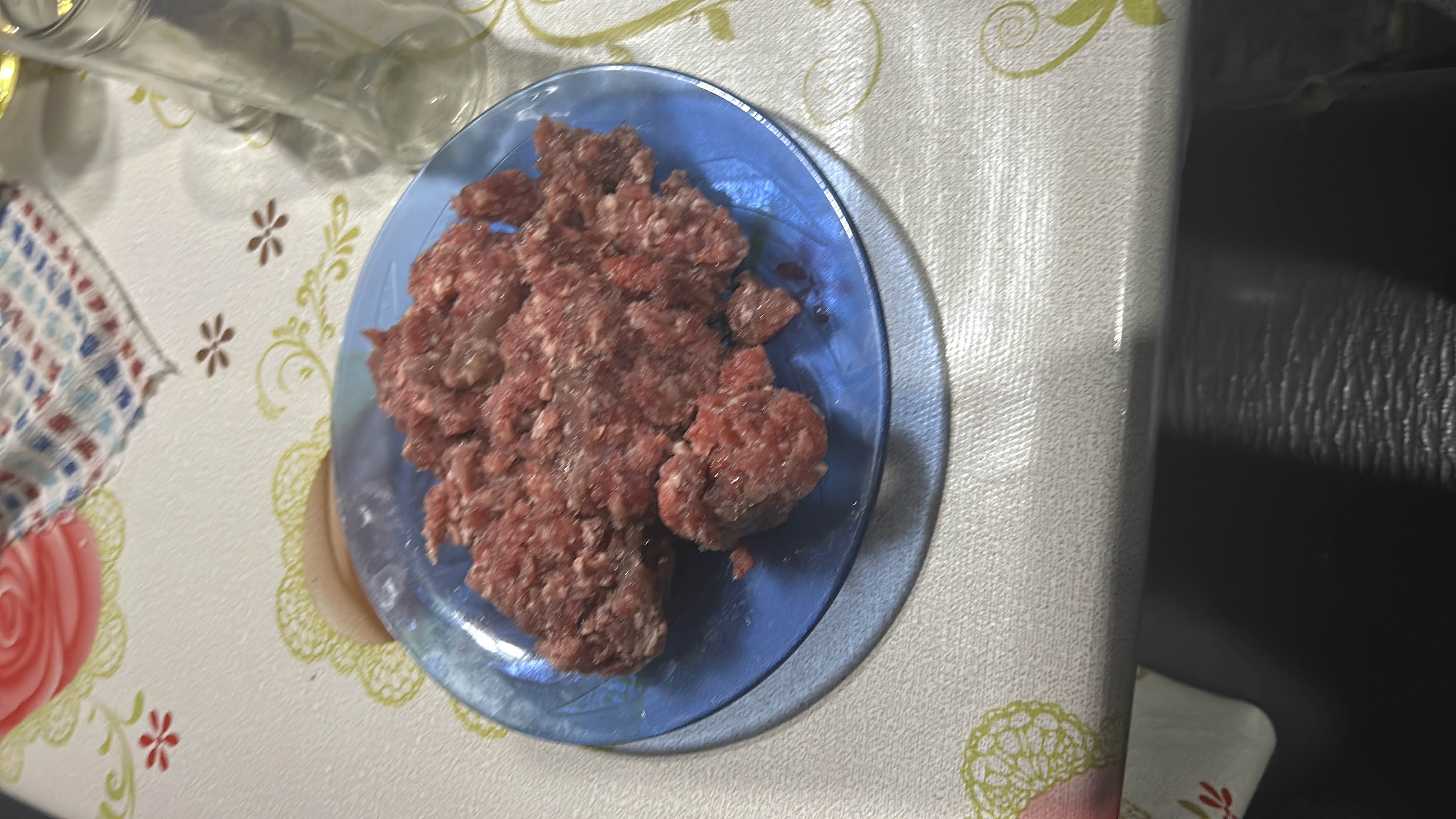 A plate of raw ground meat, high in protein and fats, suitable for various recipes.