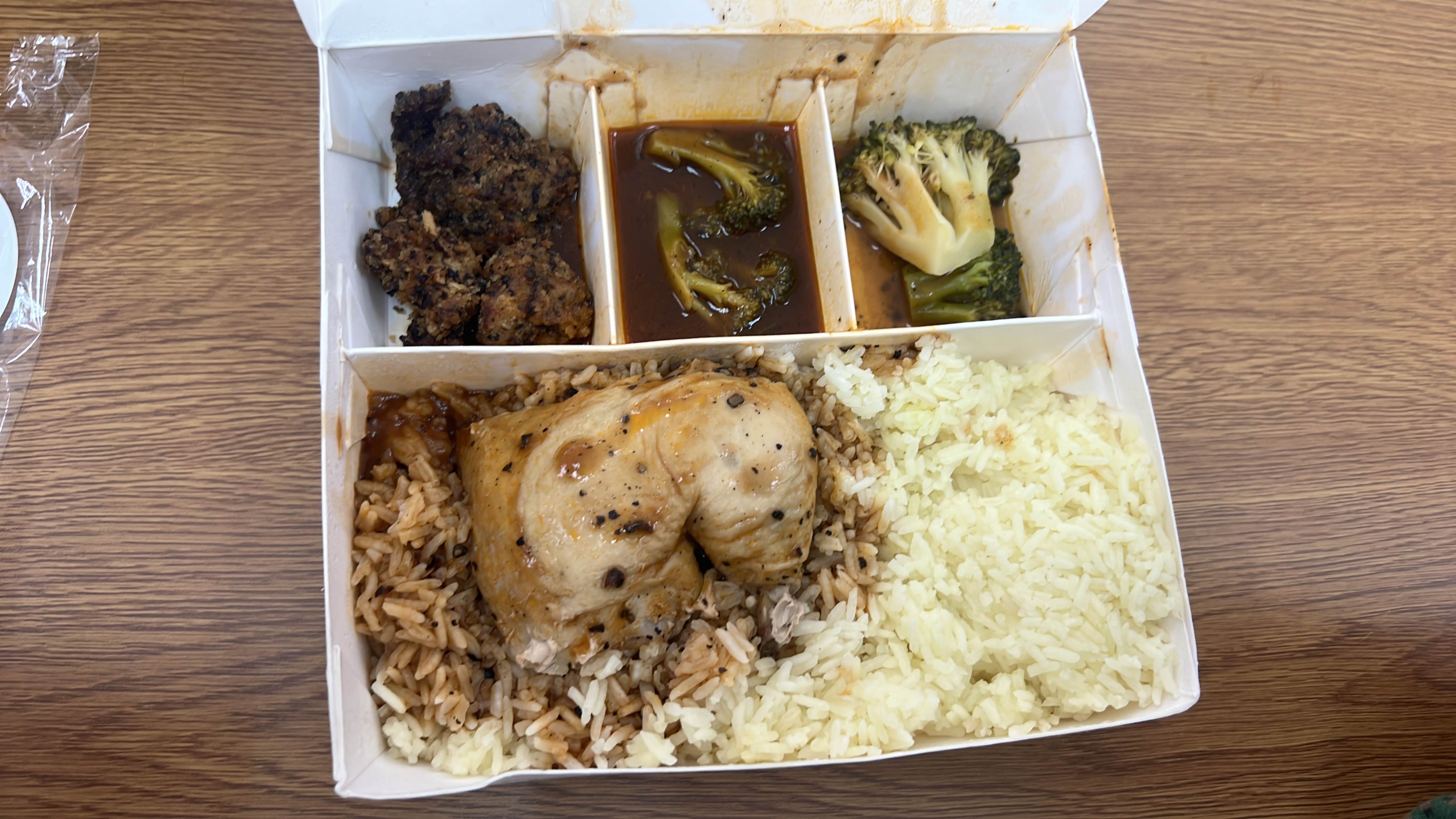 A balanced meal consisting of chicken, rice, broccoli, and sauce, providing a good mix of protein, carbs, and fats.